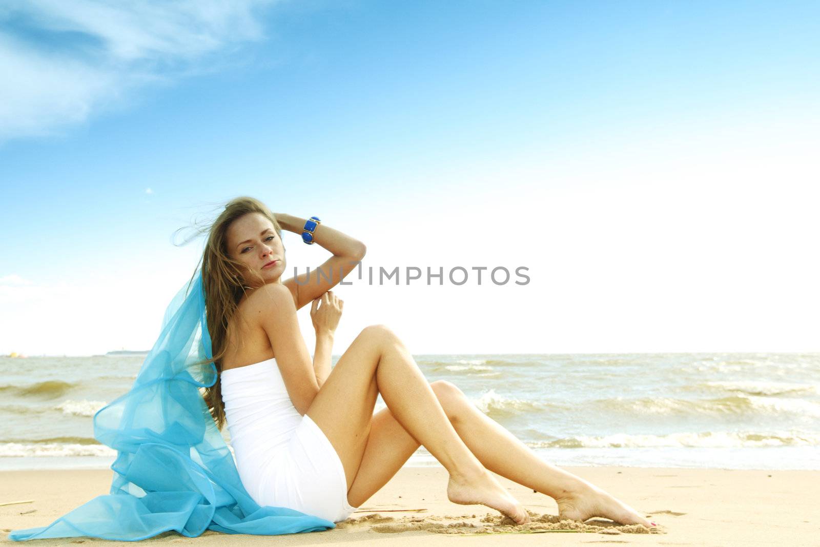 woman laying on sand sea on background