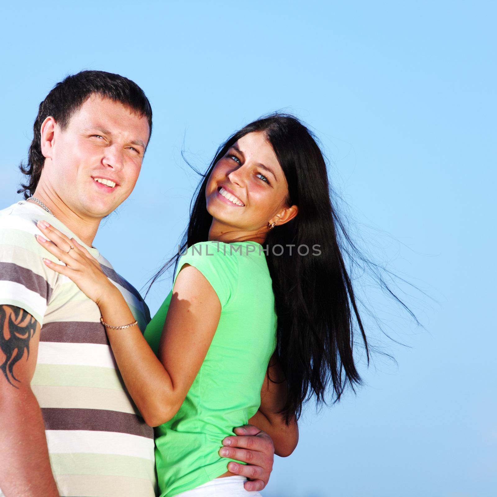 man and woman hug in the sky sea on background