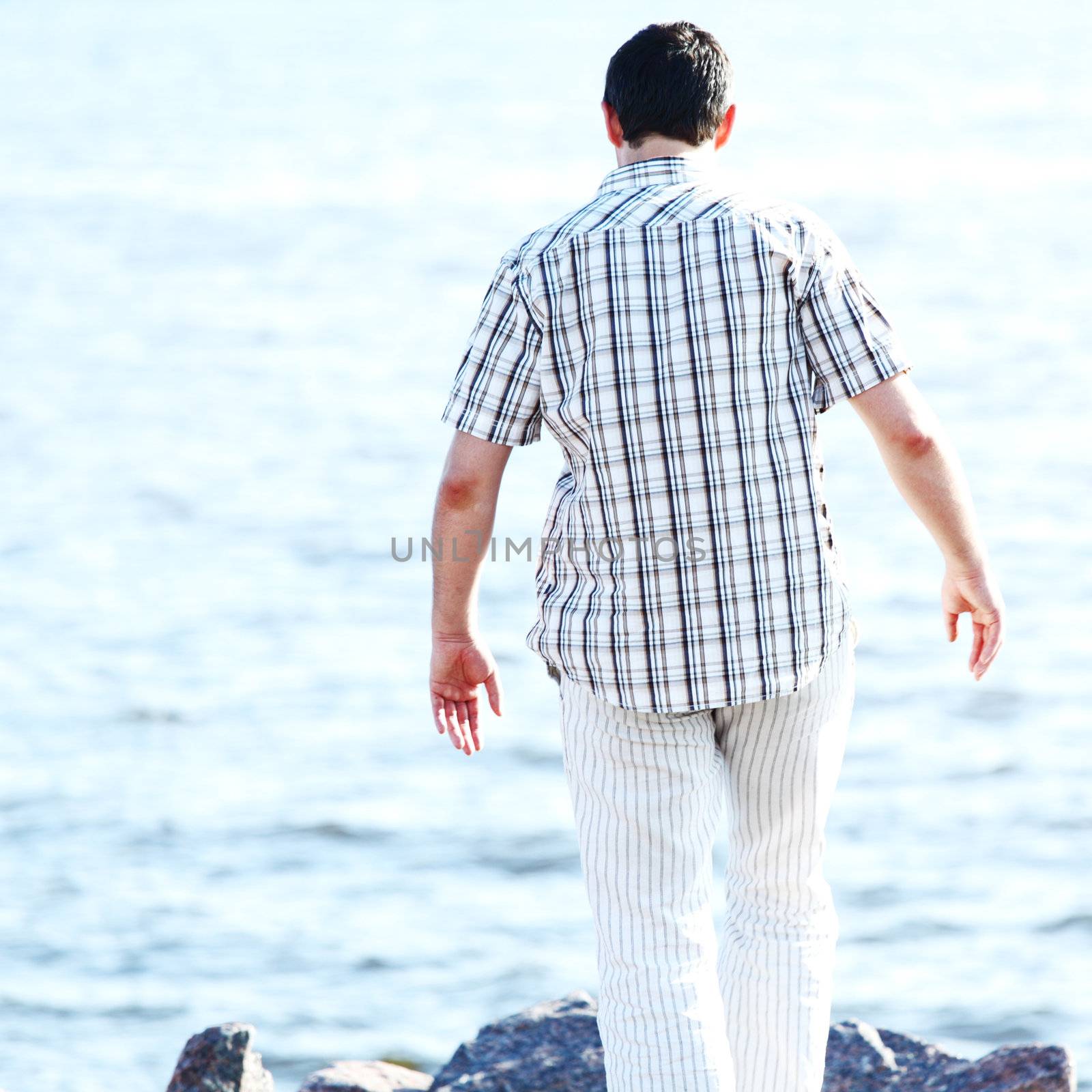 man stay on ground sea on background