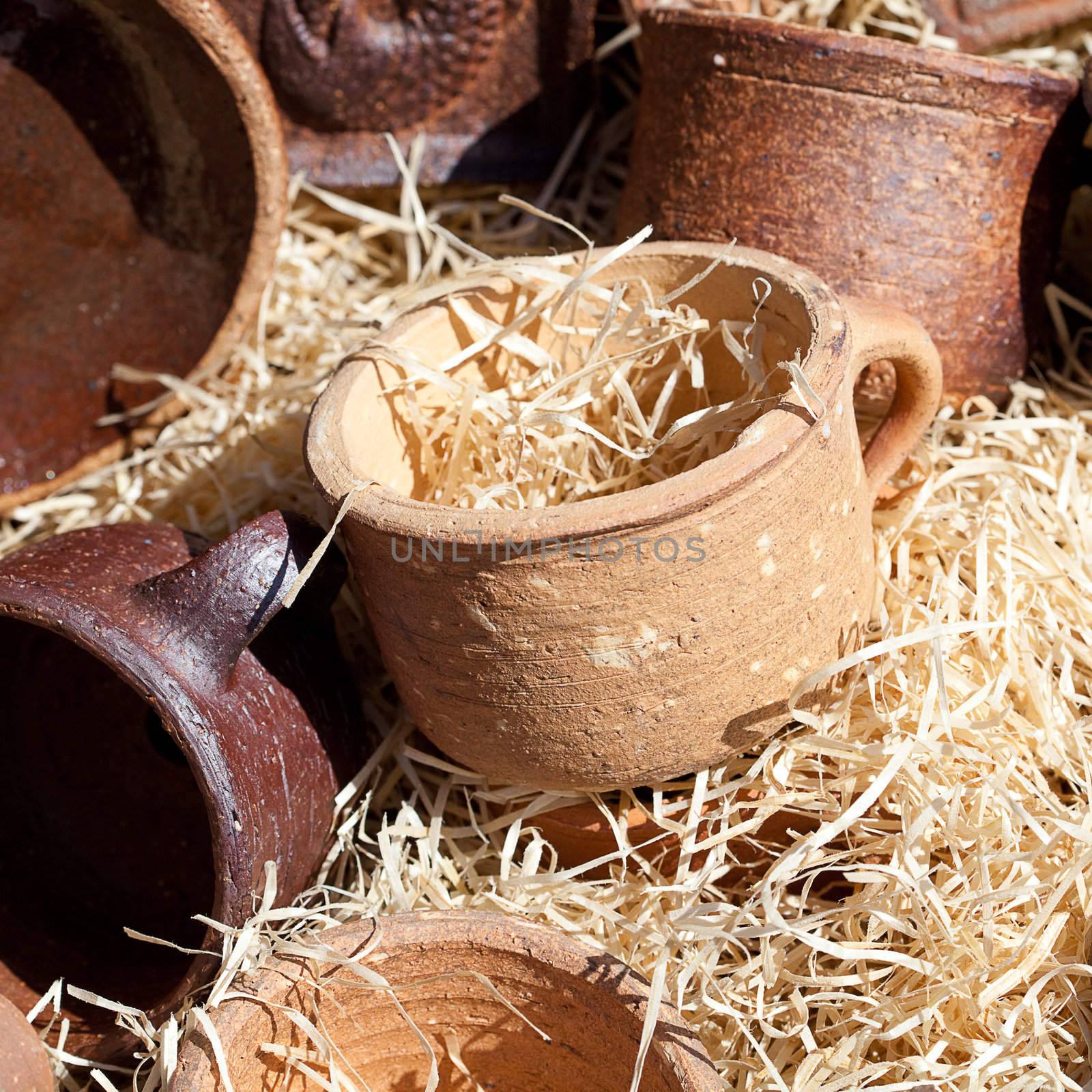 clay pots in the straw at the fair by jannyjus