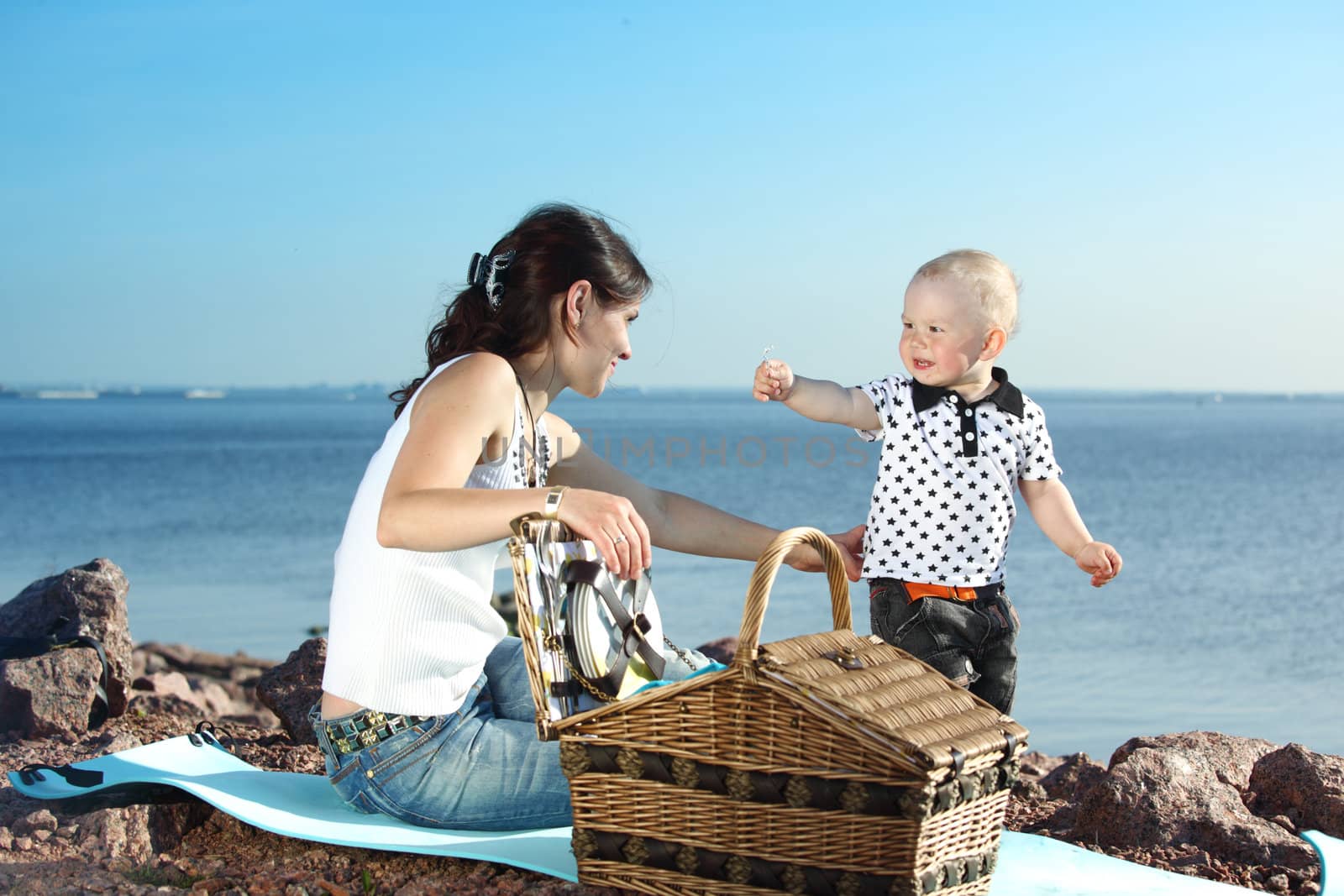 happy mother and son on picnic near sea