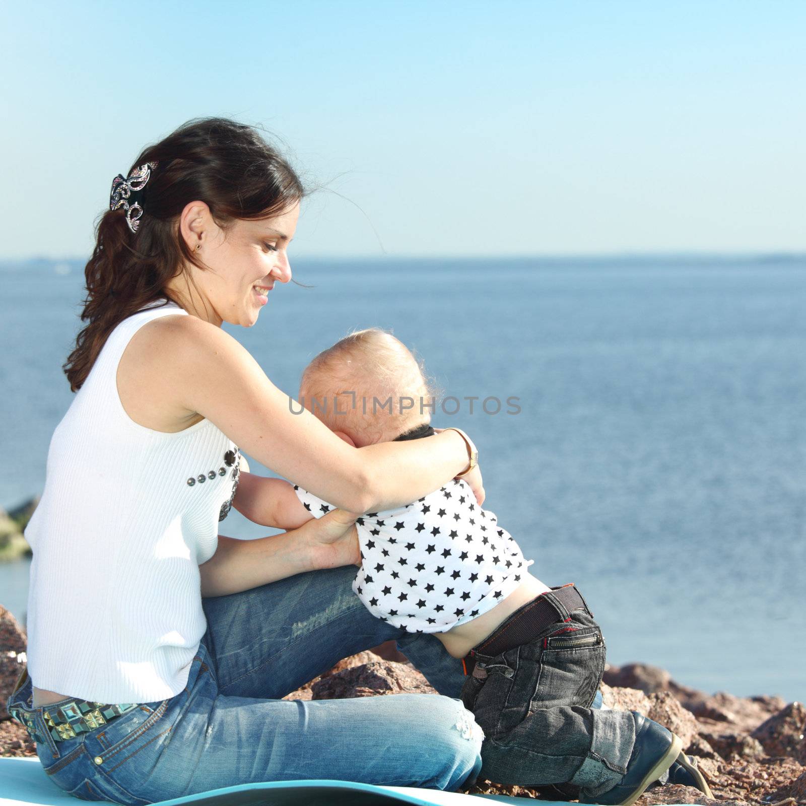 happy mother and son on picnic near sea