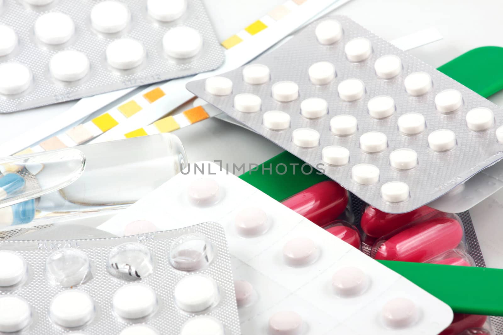 Pills of many shapes and colors grouped together.