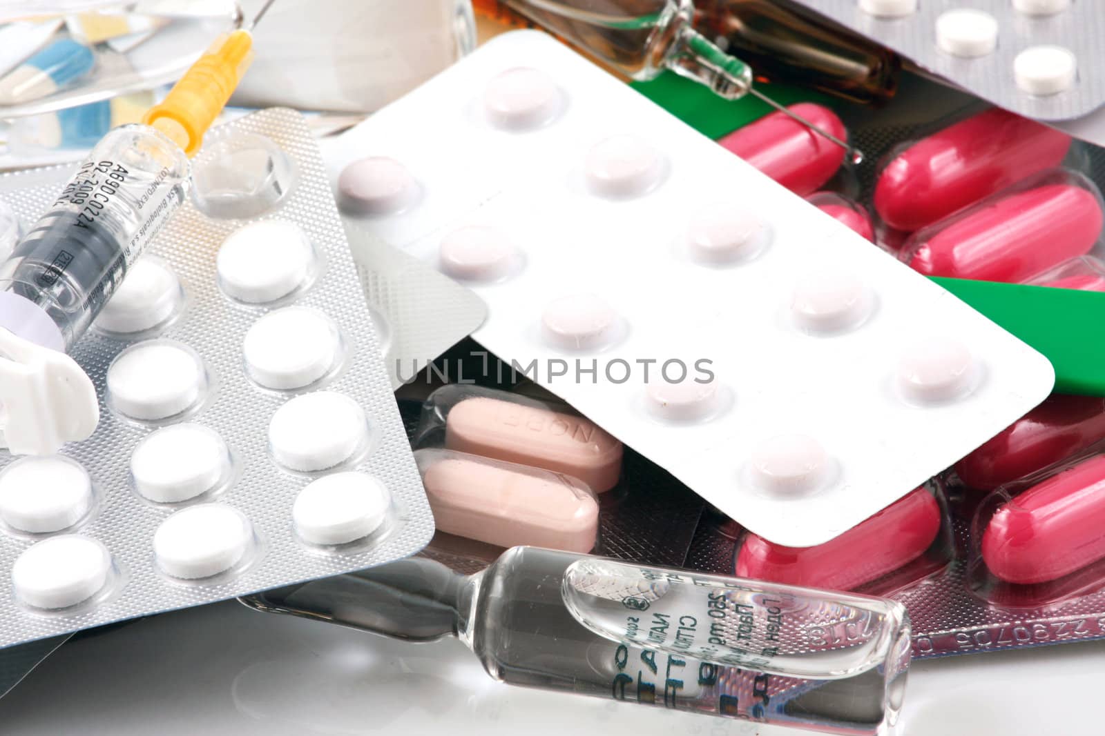 Pills of many shapes and colors grouped together.