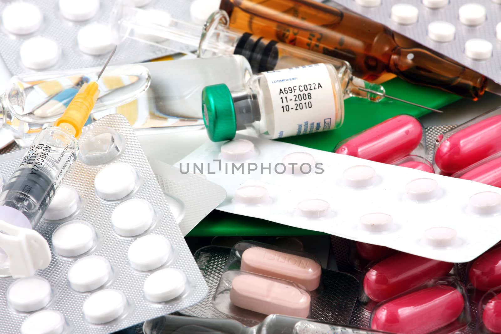 Pills of many shapes and colors grouped together.