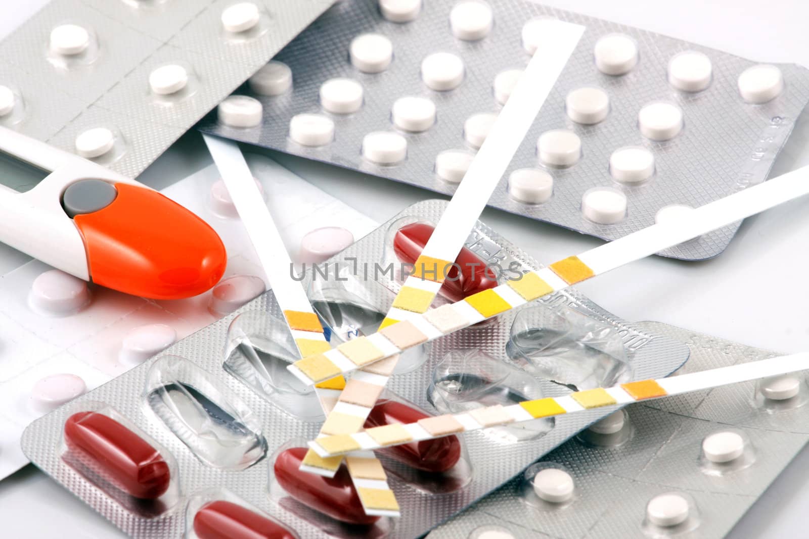 Pills of many shapes and colors grouped together.