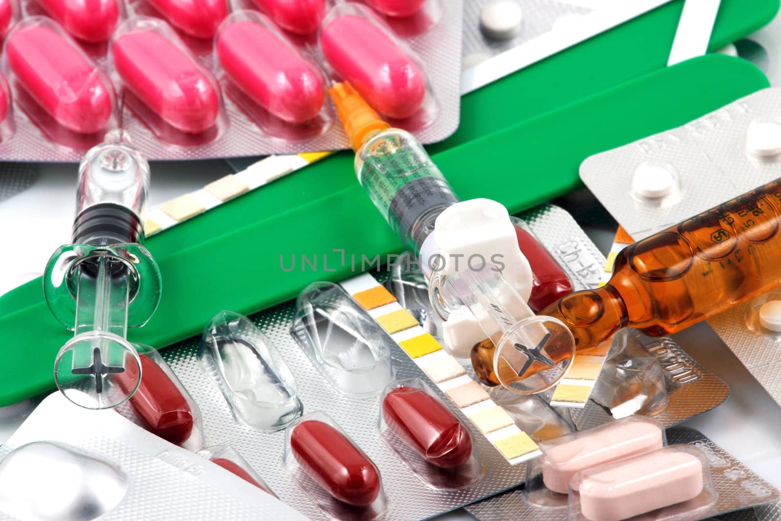 Pills of many shapes and colors grouped together.