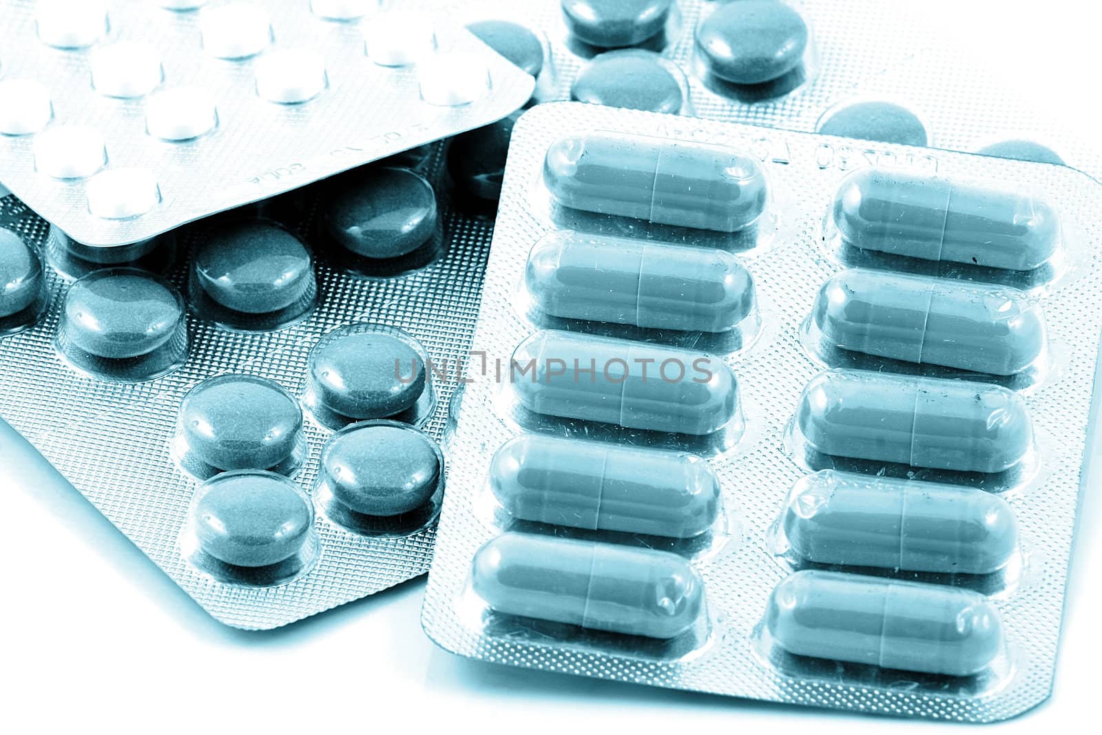 Pills of many shapes and colors grouped together.