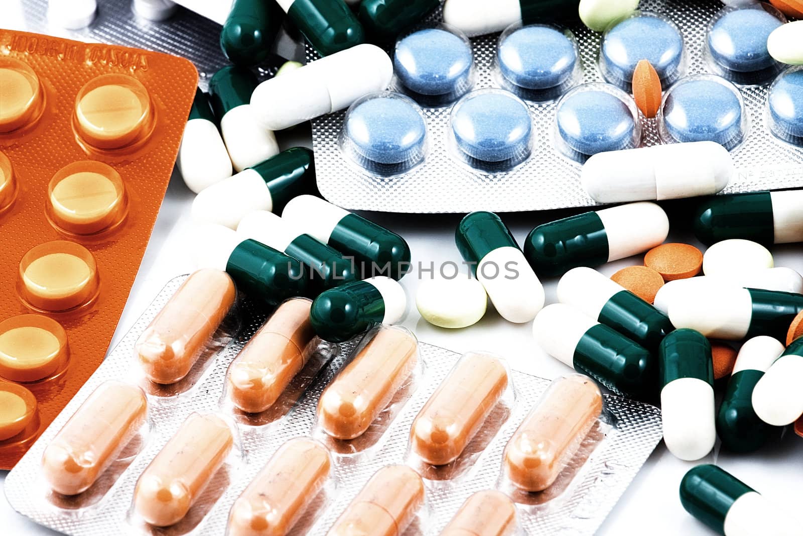 Pills of many shapes and colors grouped together.