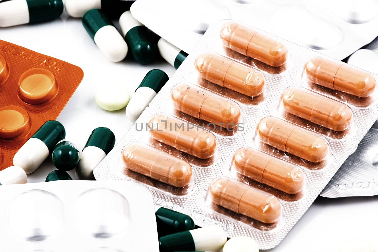 Pills of many shapes and colors grouped together.