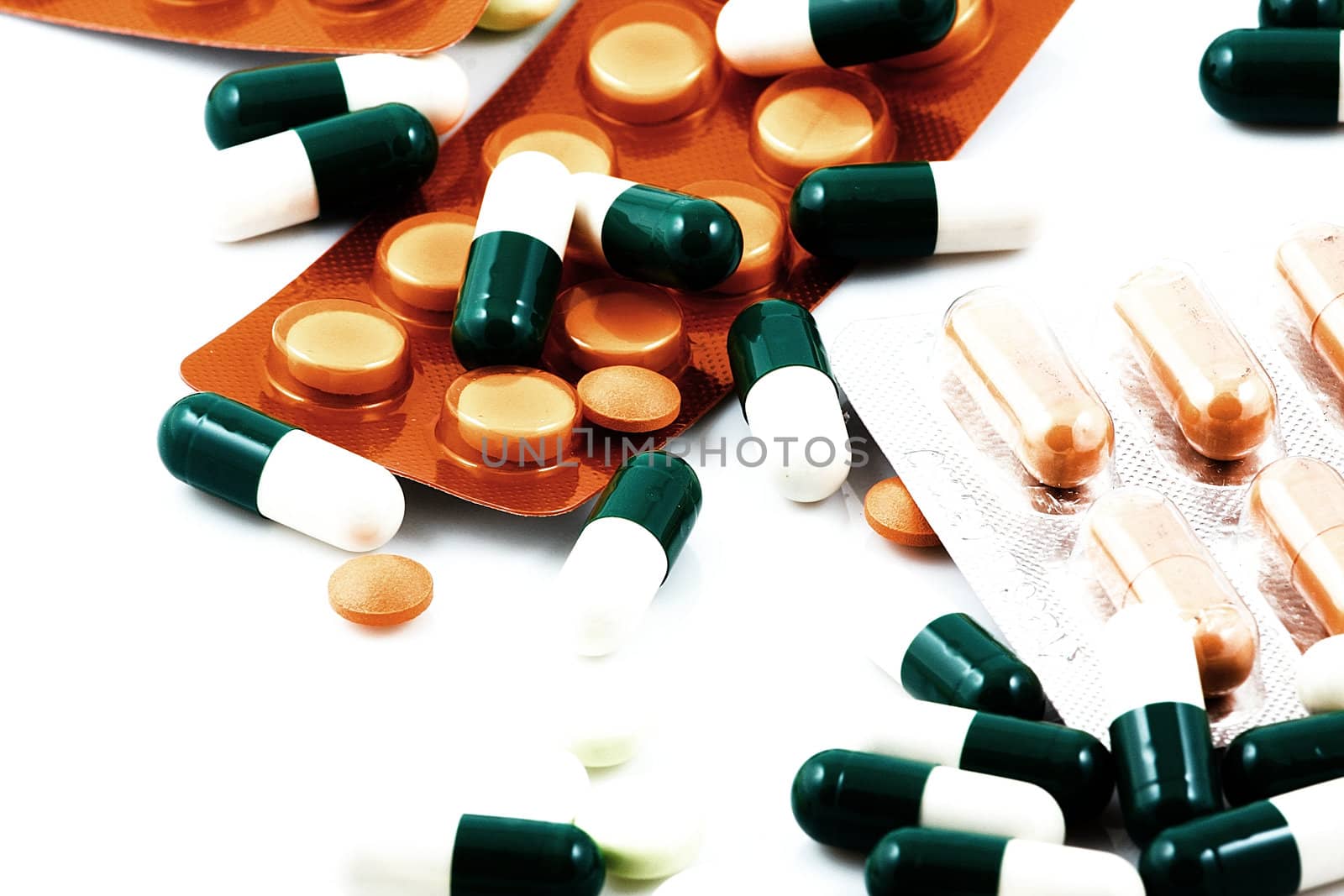 Pills of many shapes and colors grouped together.