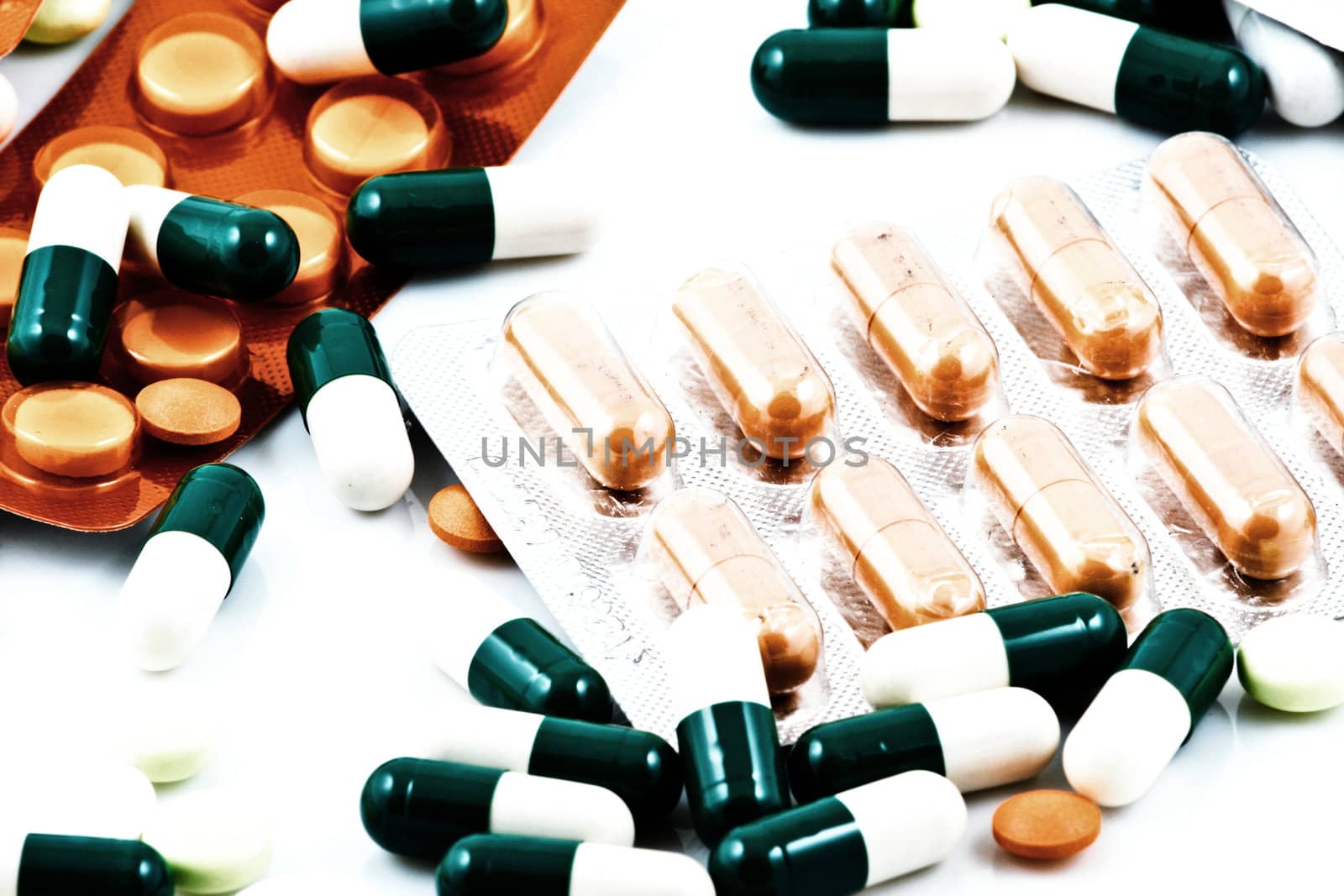 Pills of many shapes and colors grouped together.