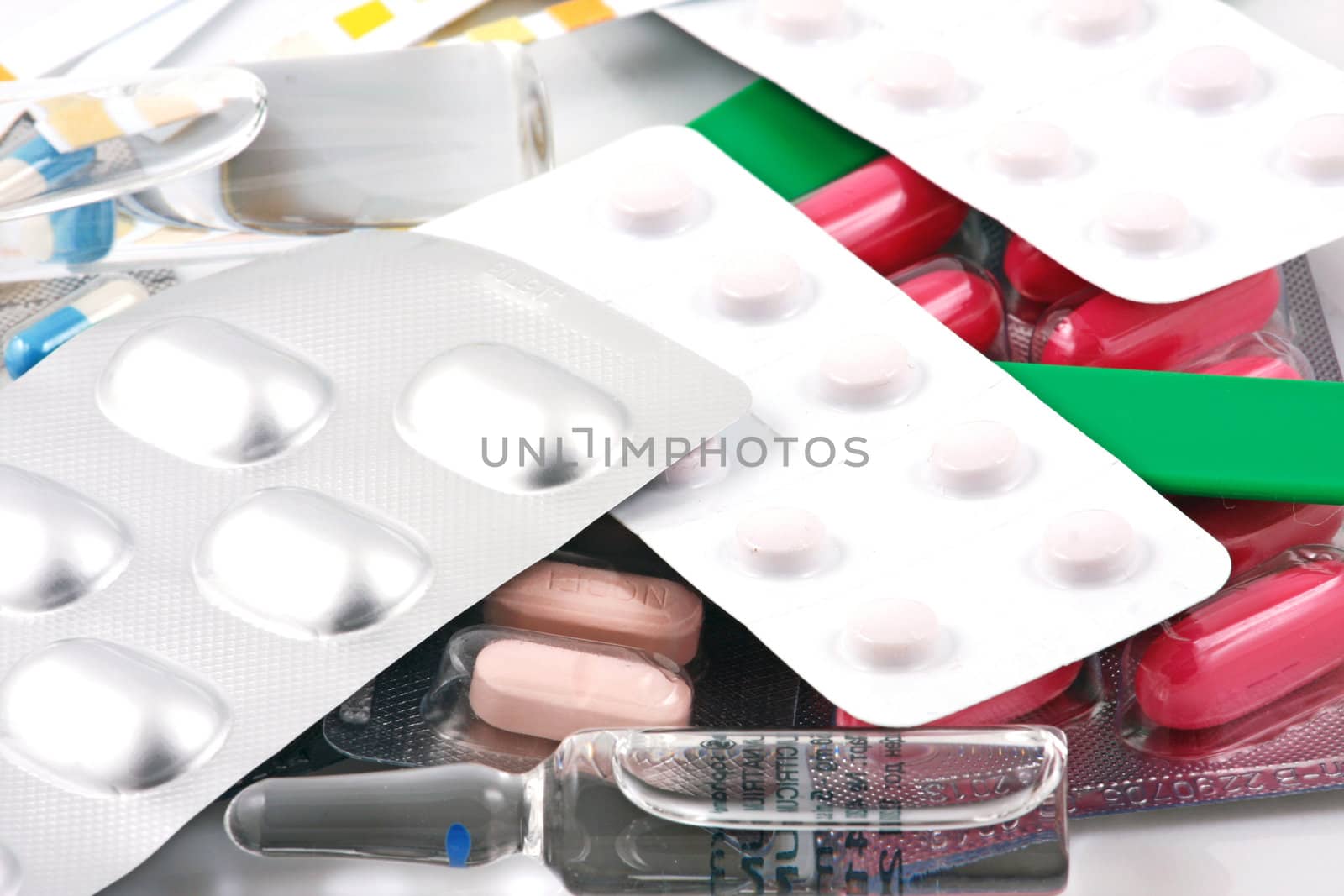 Pills of many shapes and colors grouped together.