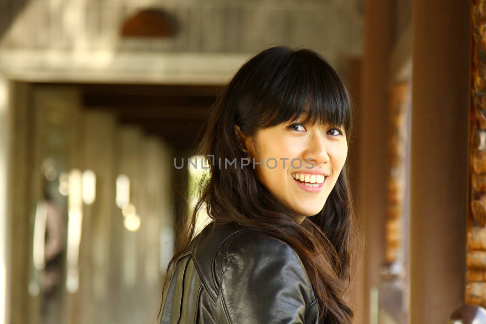 Asian woman in a garden smiling