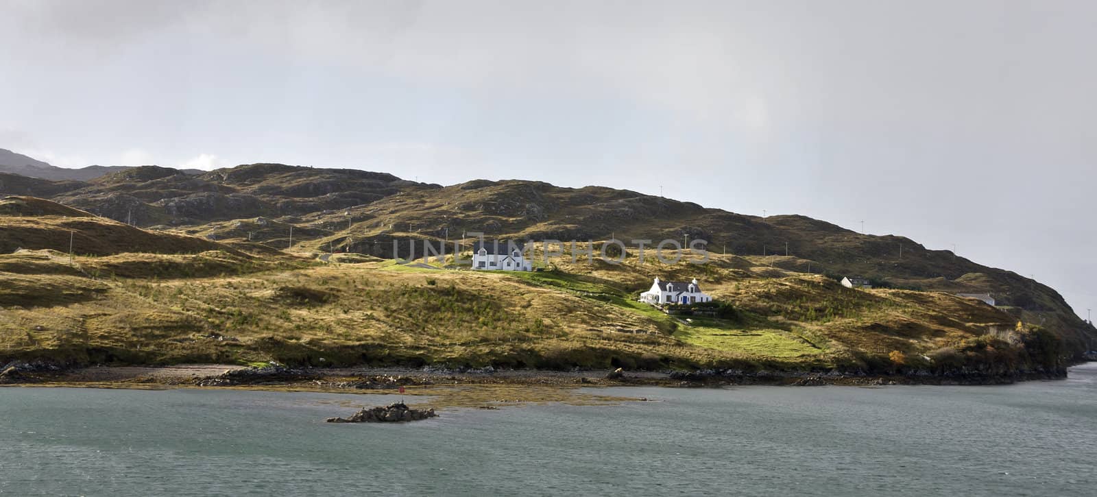 two remote houses at coastline in scotland.