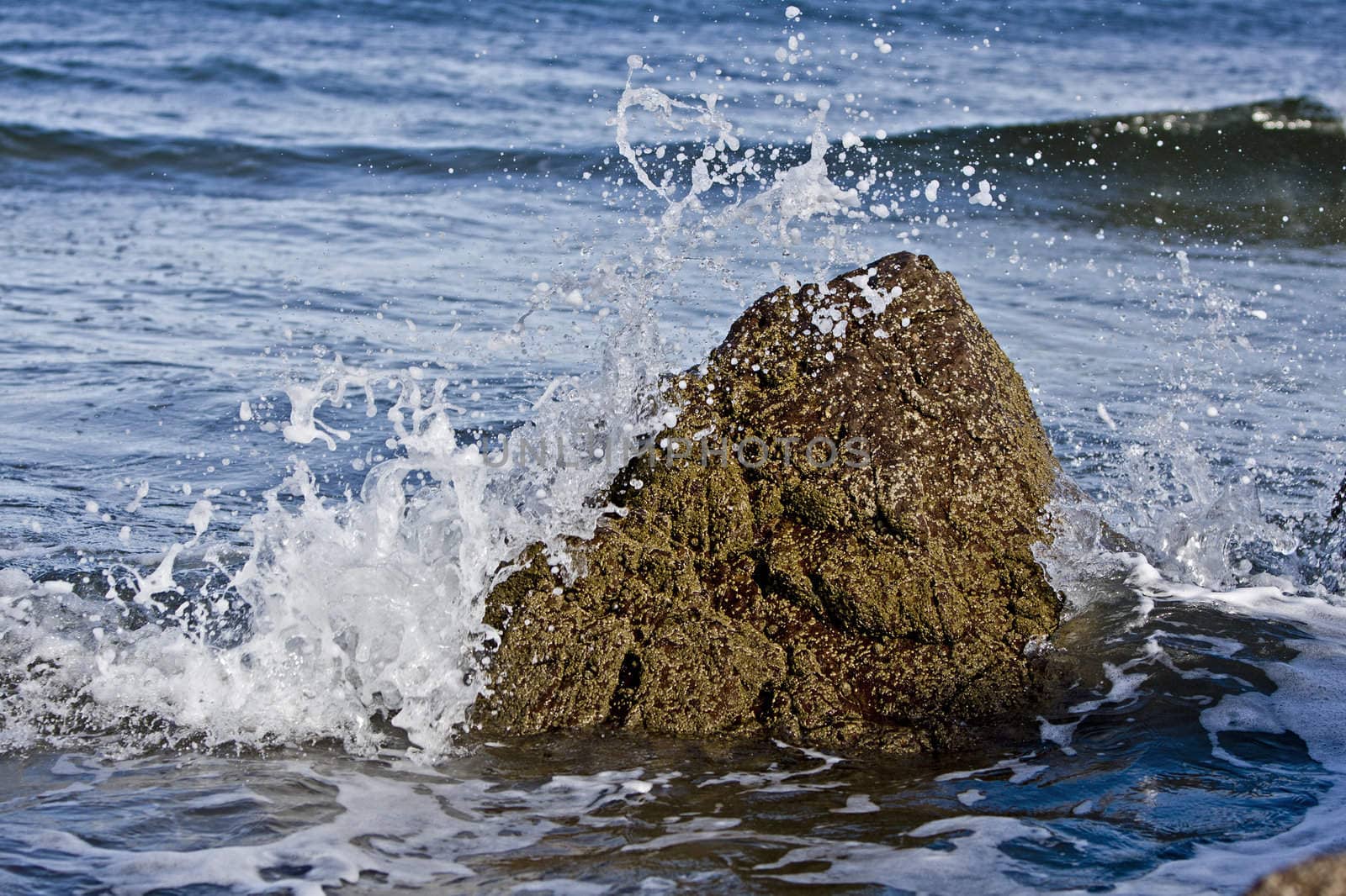 small rock resisting the wave of the atlantic ocean. Scotland, UK