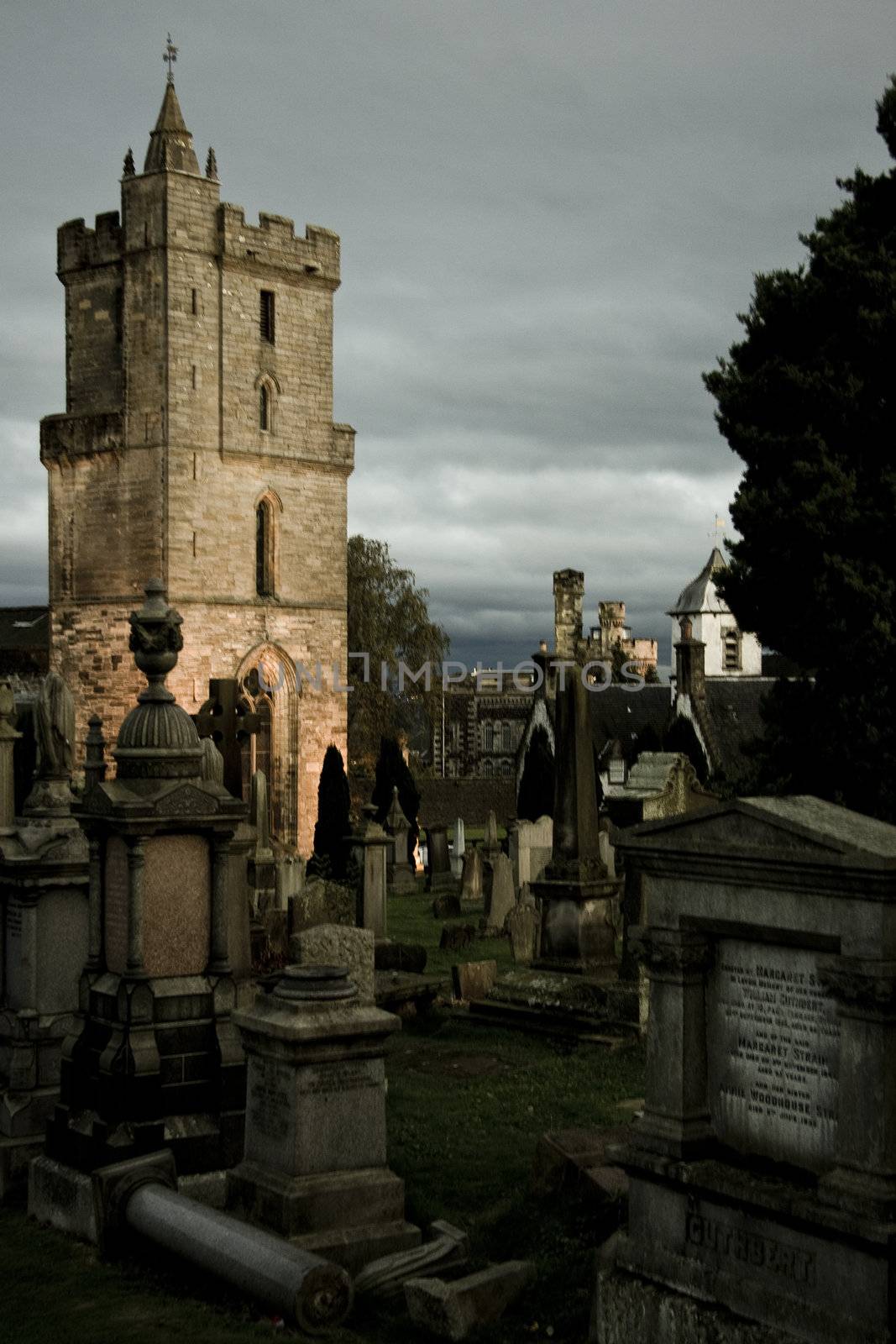 mystic cemetery in stirling with illuminated tower in background