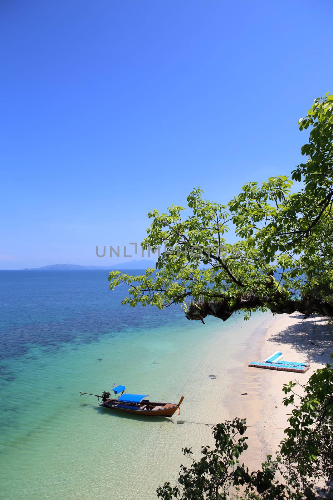 Traditional Thai longtail boat at the beach by rufous