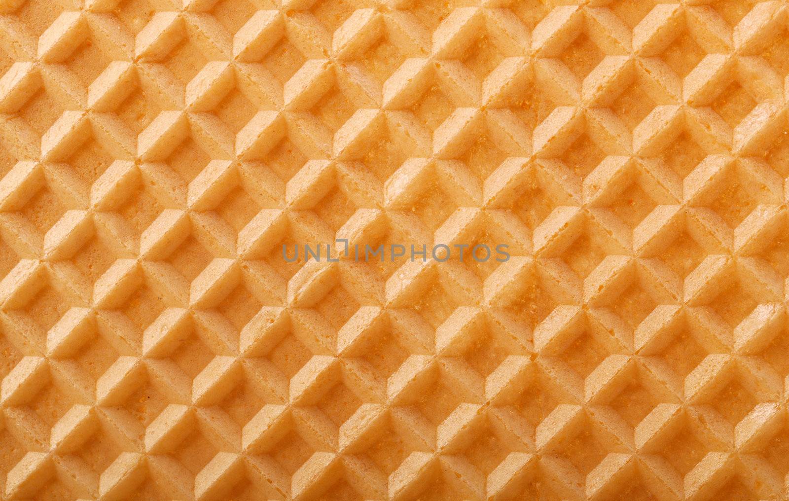 Structure of a baked golden waffle background by motorolka