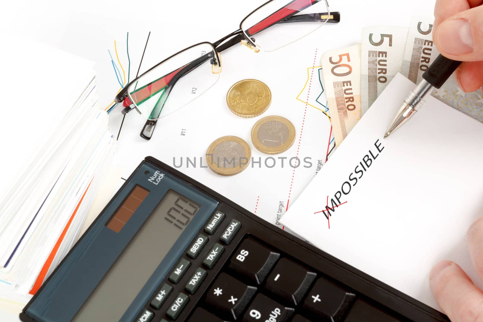 changing impossible word to possible, calculator, charts, pen in hand, money, workplace businessman