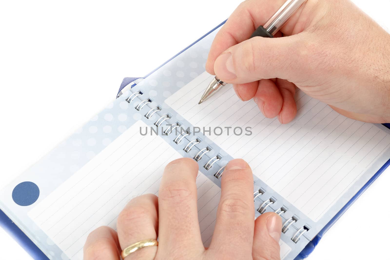 Close-up of hand beginning to write on notes on white background
