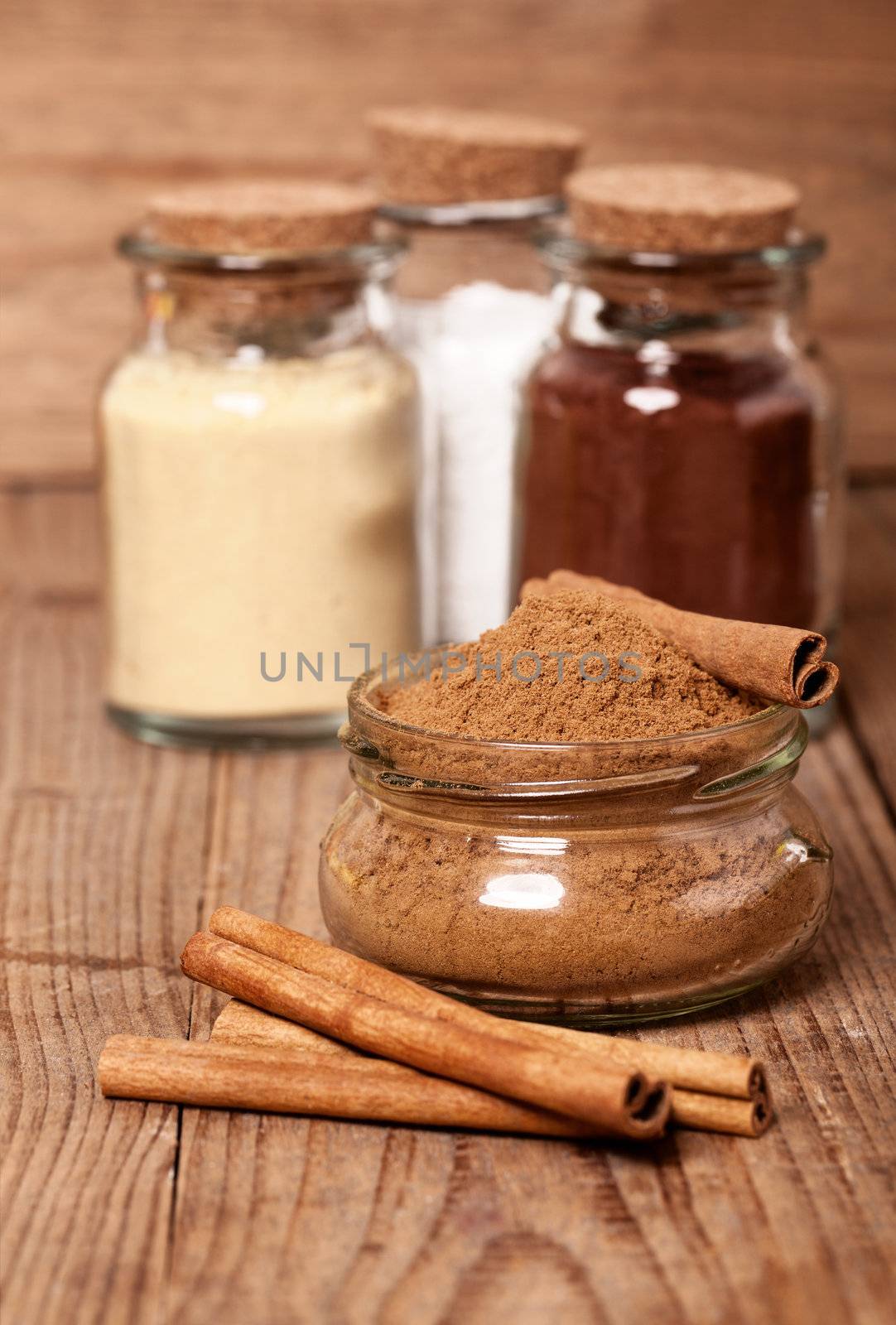 cinnamon, or chinese cinnamon in the transparent glass jar with  Cinnamon sticks, on wooden table