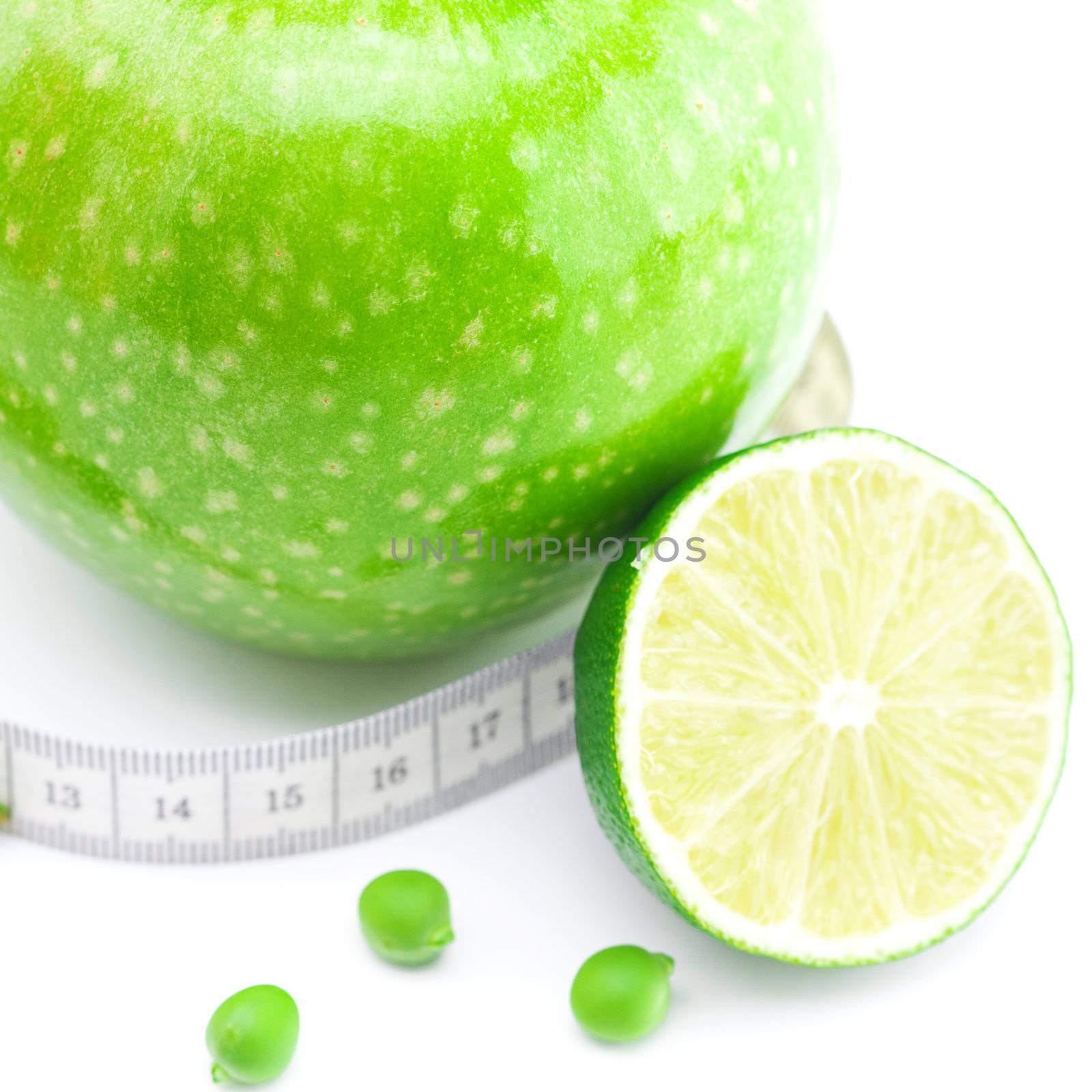 apple,lime,peas and measure tape isolated on white by jannyjus