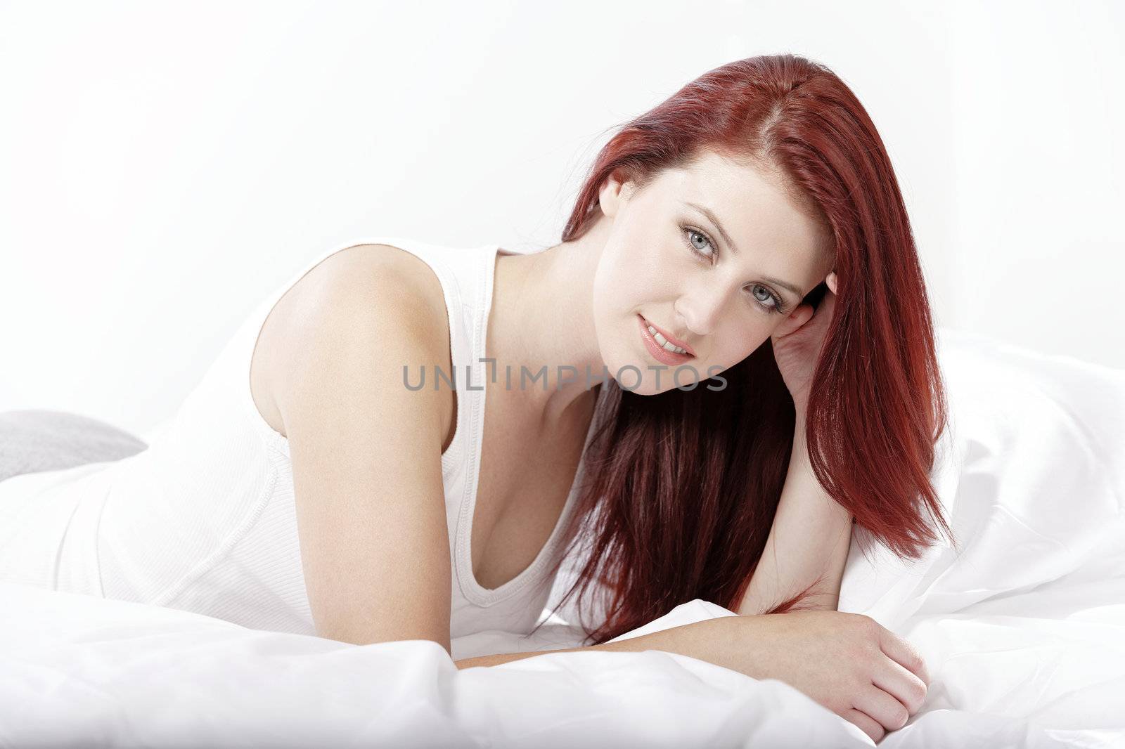 Woman lying on bed by studiofi