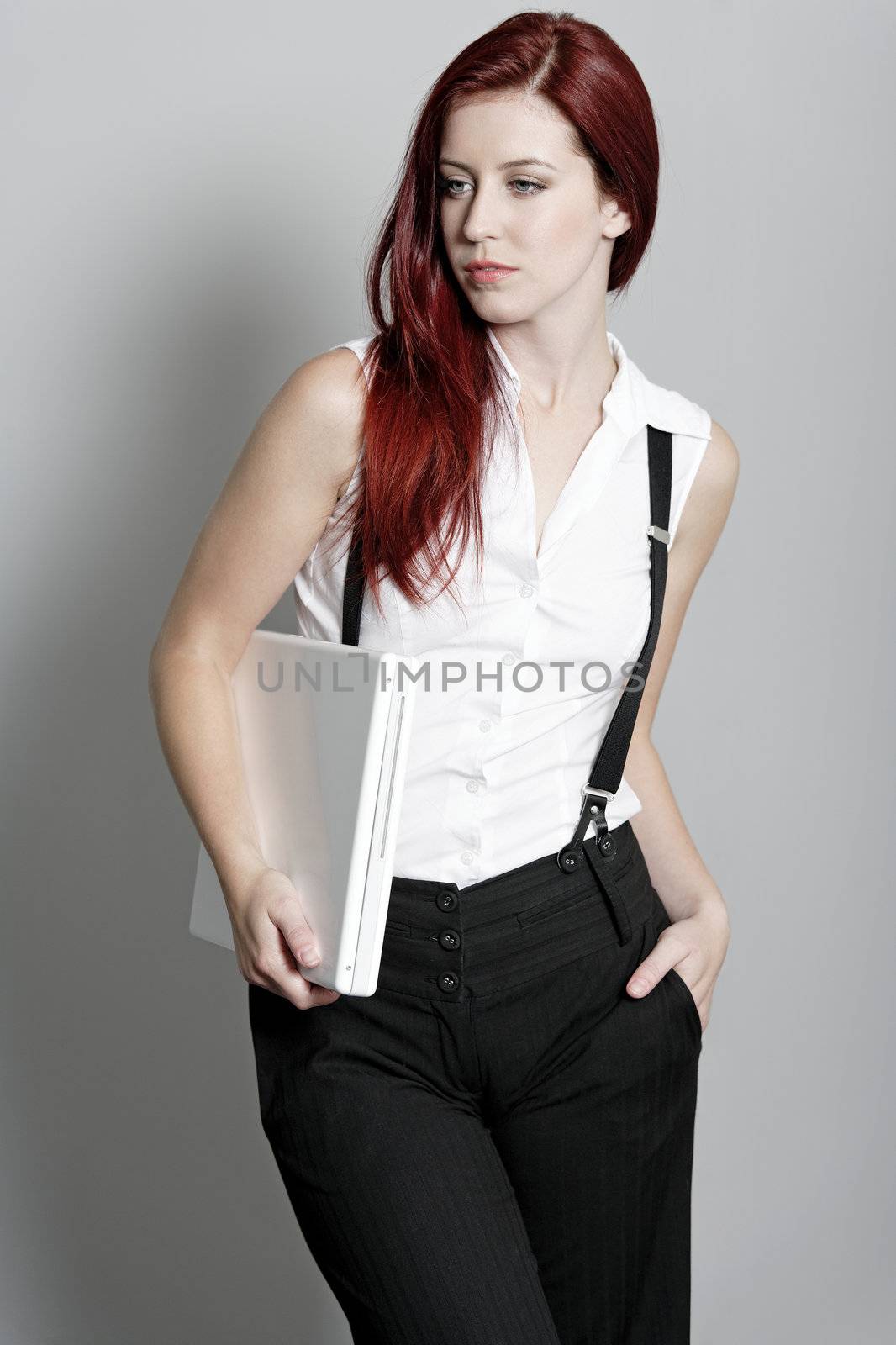 Business woman holding laptop by studiofi