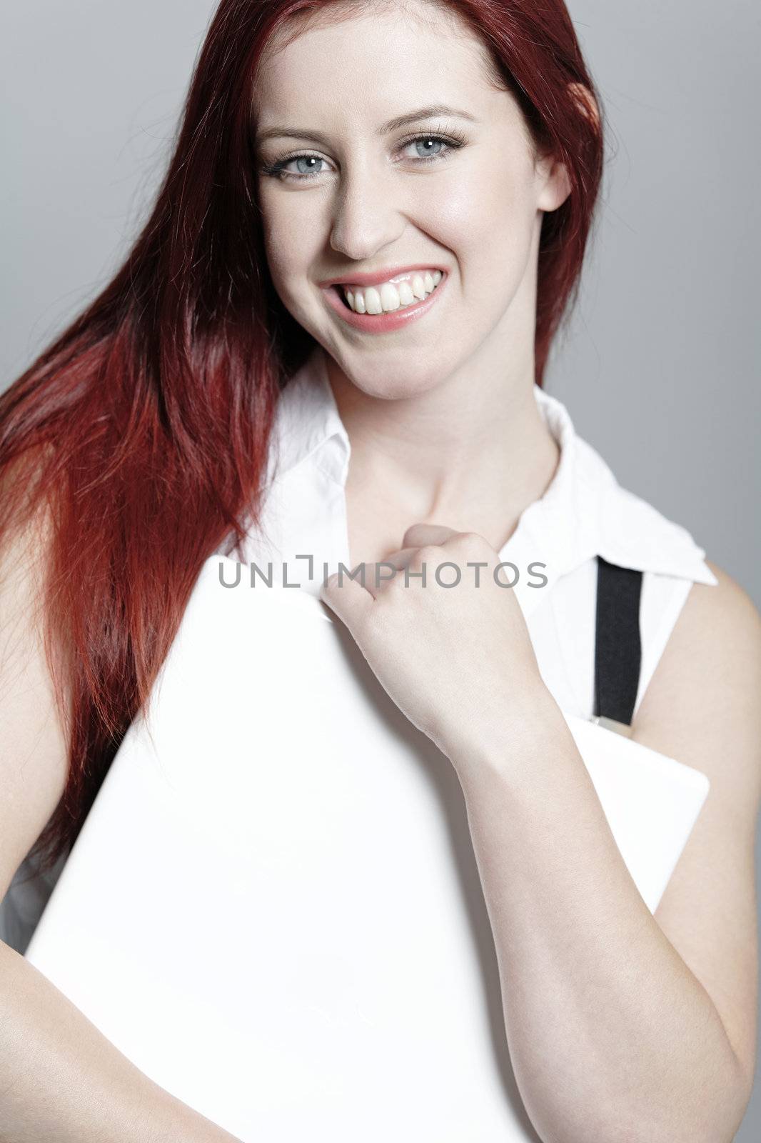 Professional business woman holding a white laptop at work