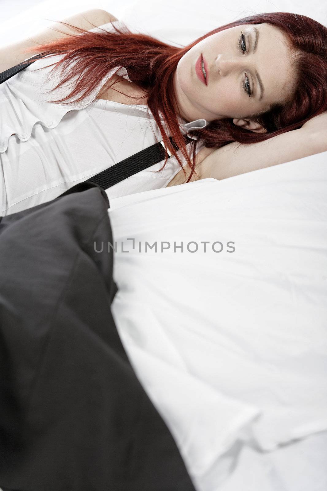 Business woman resting on bed by studiofi