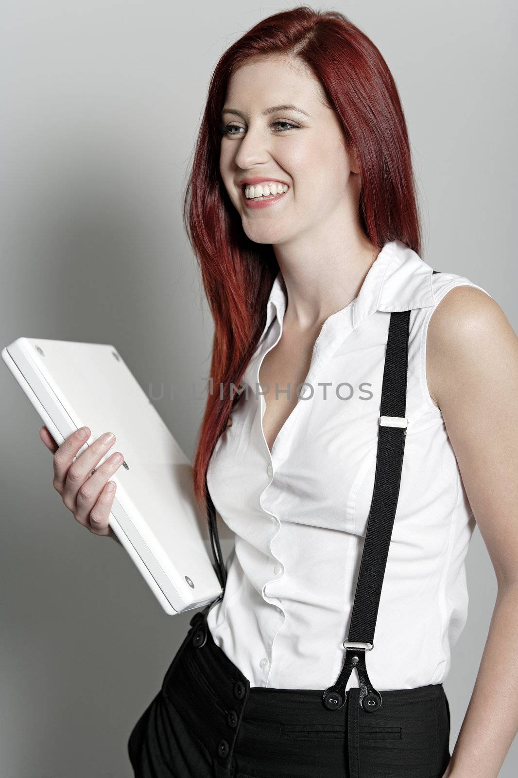 Professional business woman holding a white laptop at work