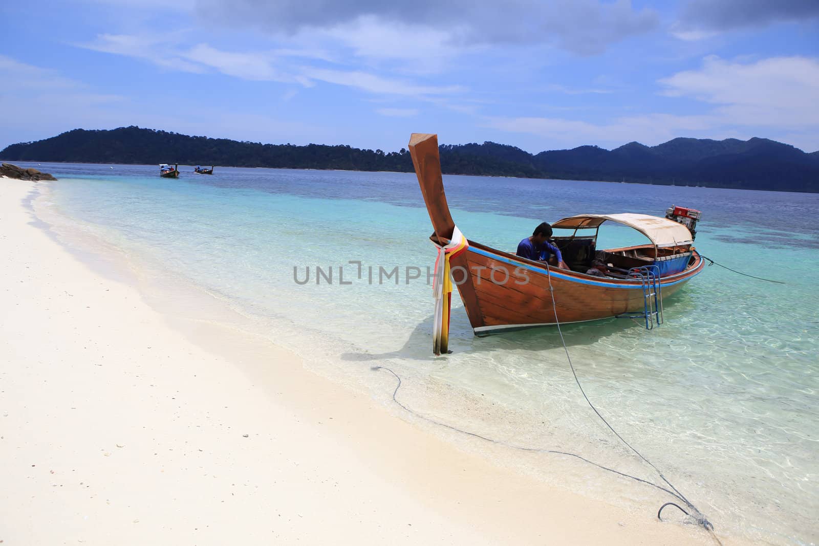 Traditional Thai longtail boat at the beach by rufous