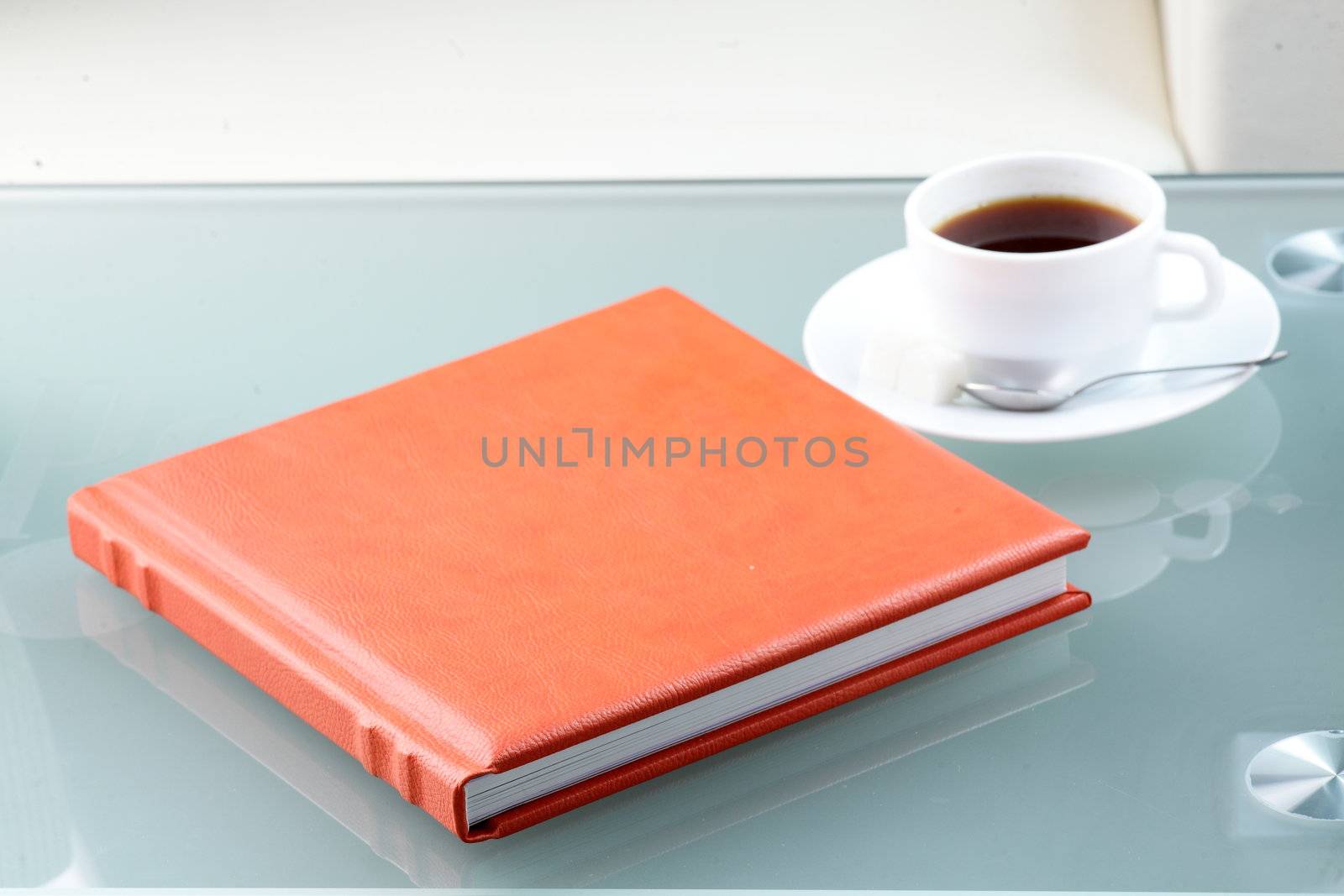 orange leather book on bright background