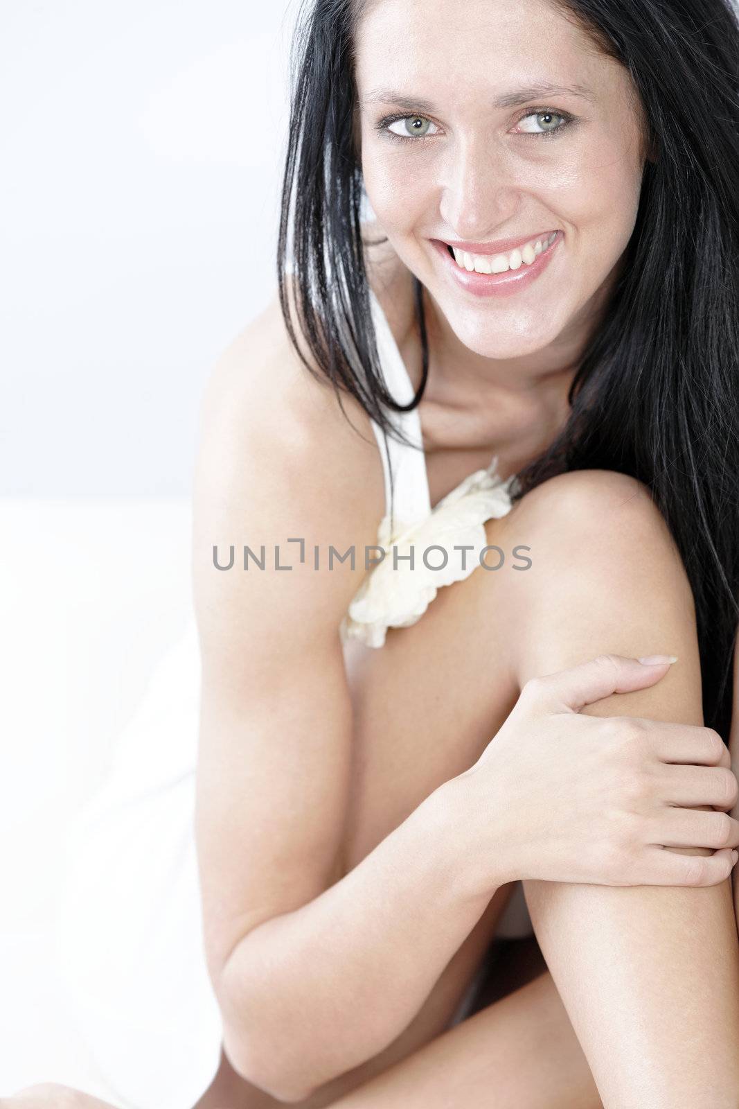 Woman in white dress sitting by studiofi