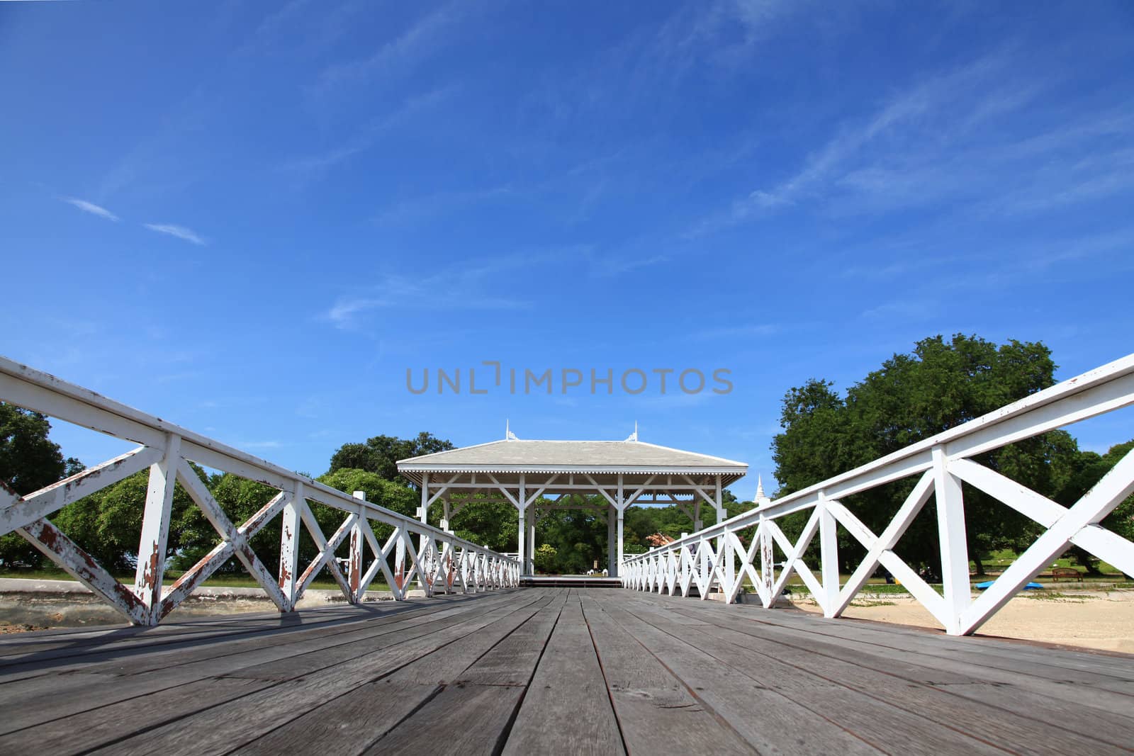 wooden jetty walkway with pavillion in Srichang Island Thailand with blue sky
