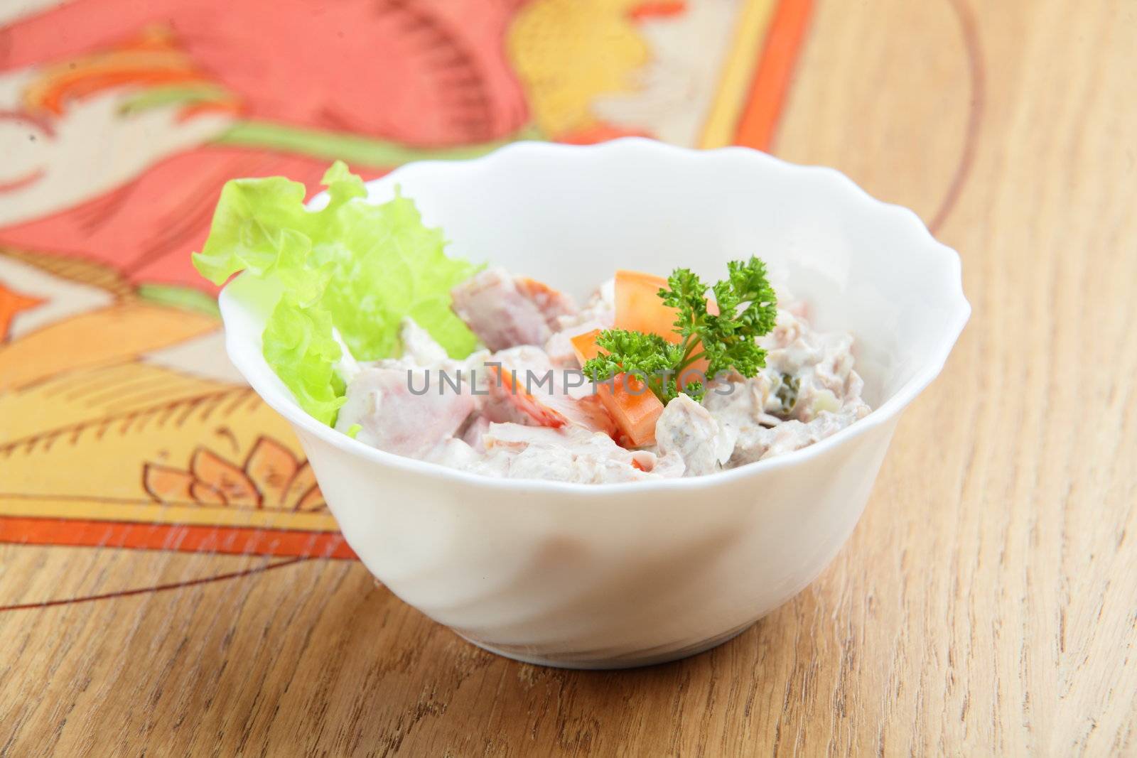 salad in white dish and wooden background