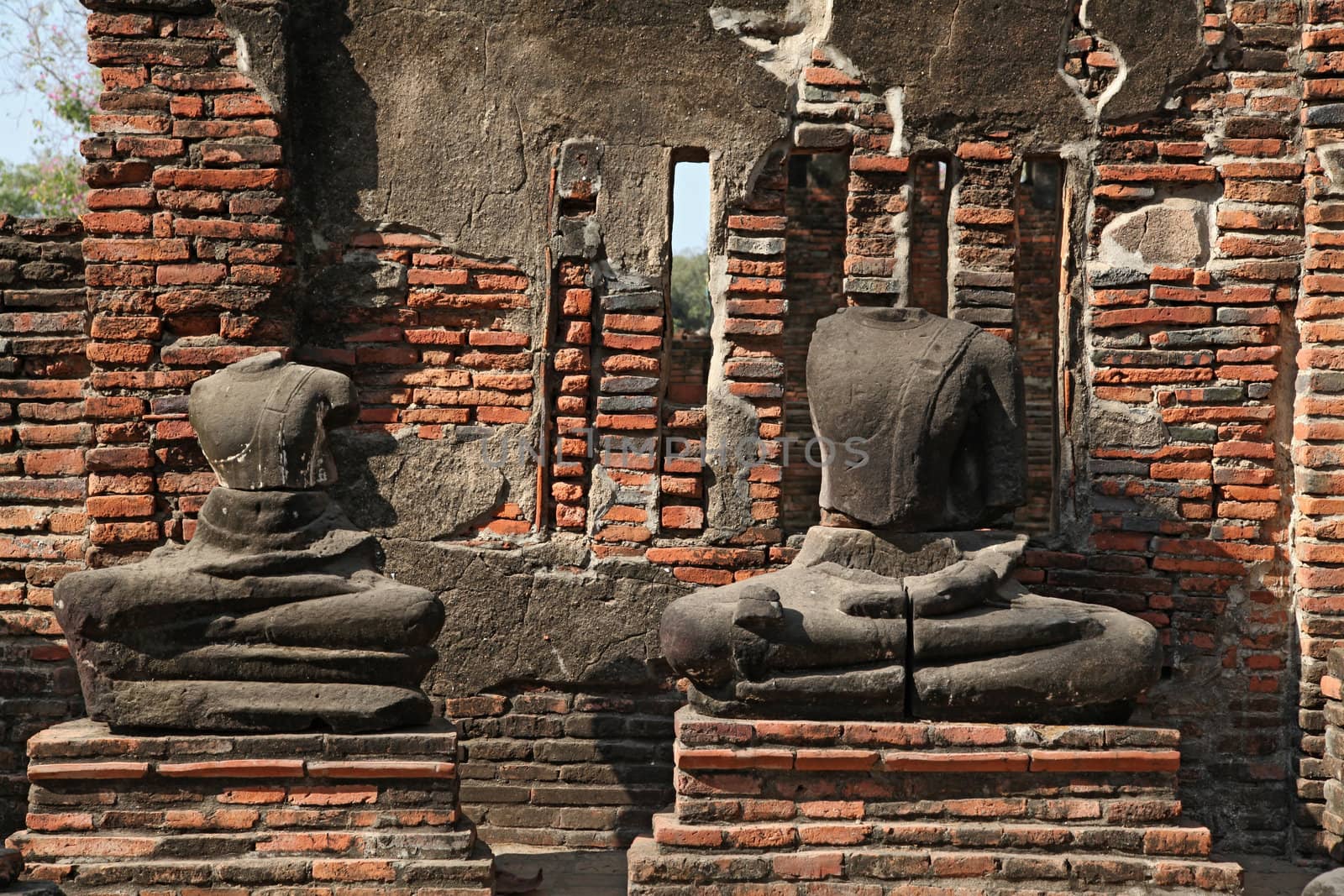 headless buddha statue in temple ruin , bangkok thailand