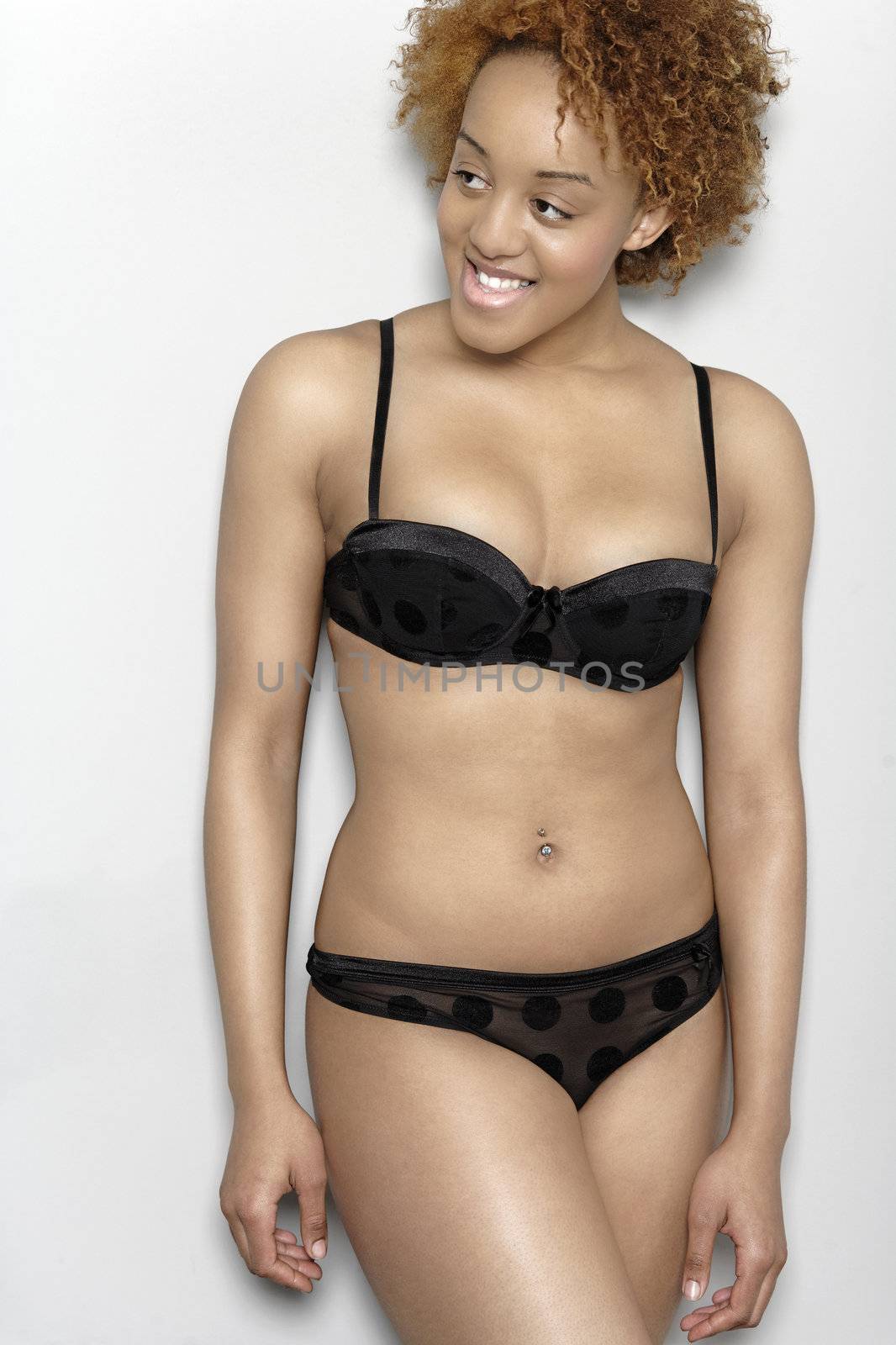 Sexy young black woman in lingerie smiling in lingerie smiling