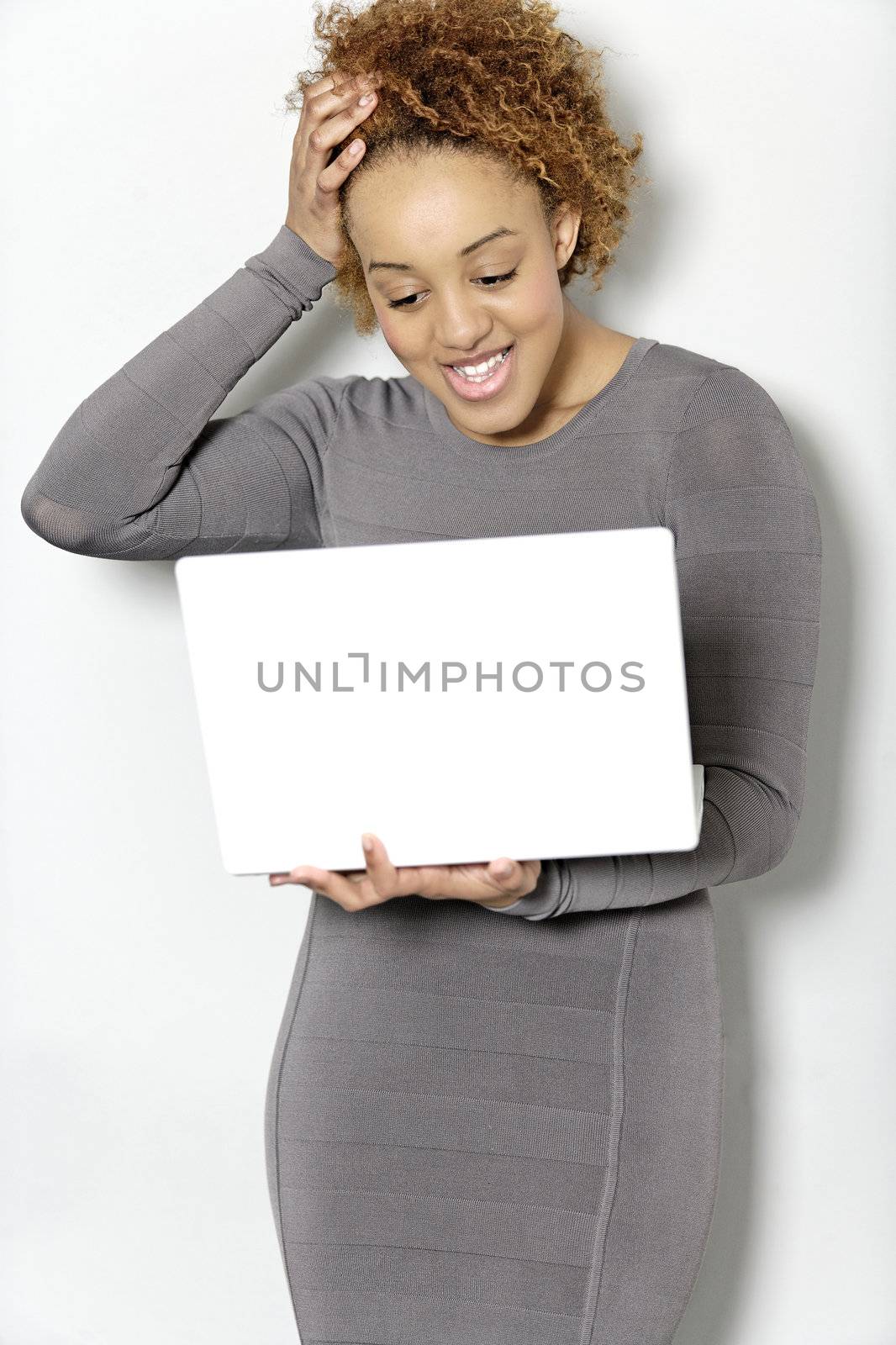 Beautiful young woman holding a laptop computer working