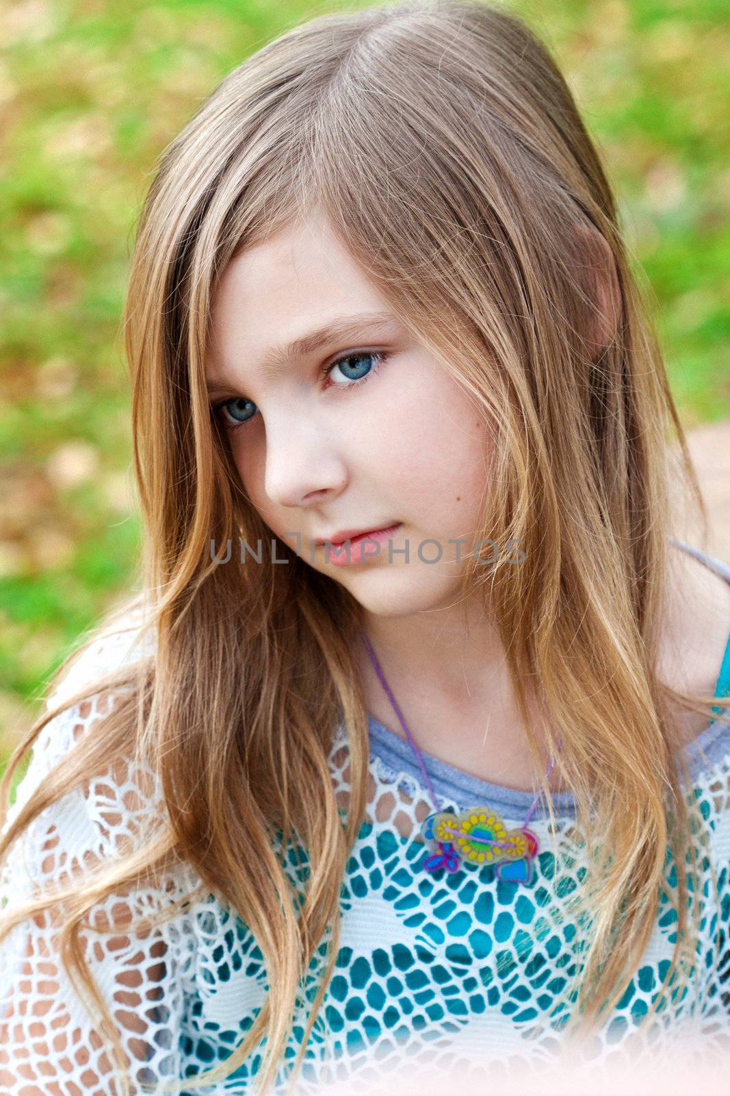 Portrait of a blode girl outdoors in the park 