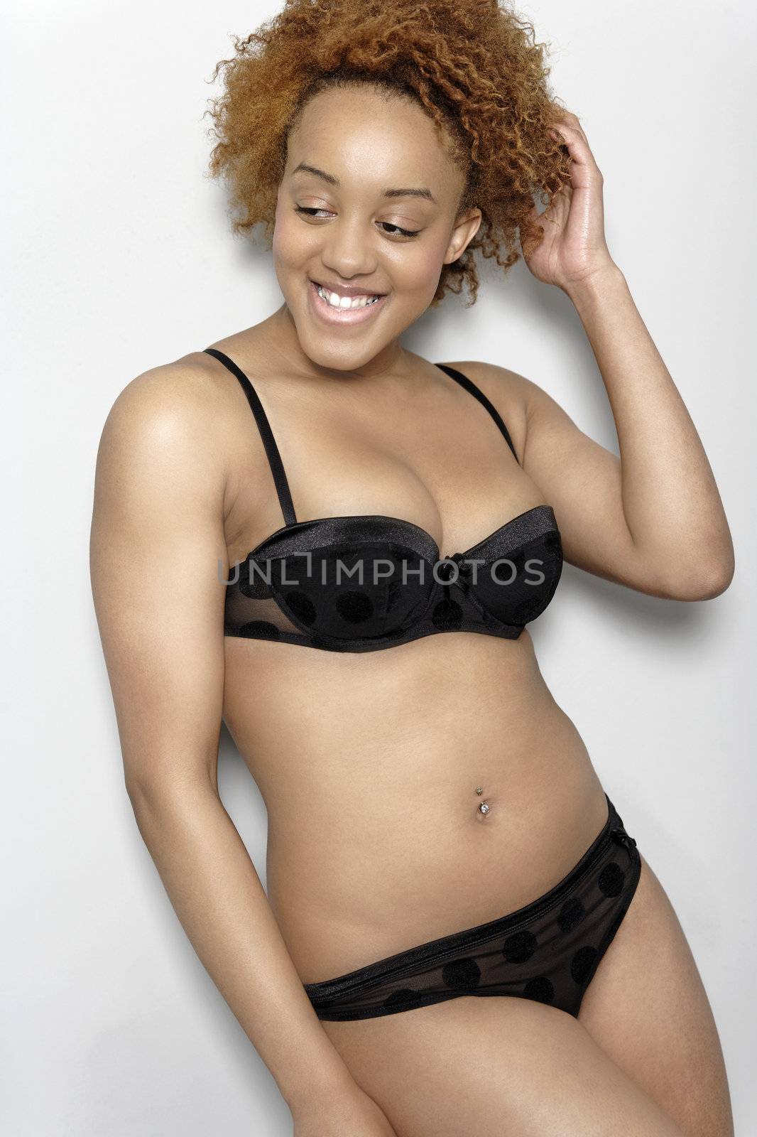 Sexy young black woman in lingerie smiling in lingerie smiling