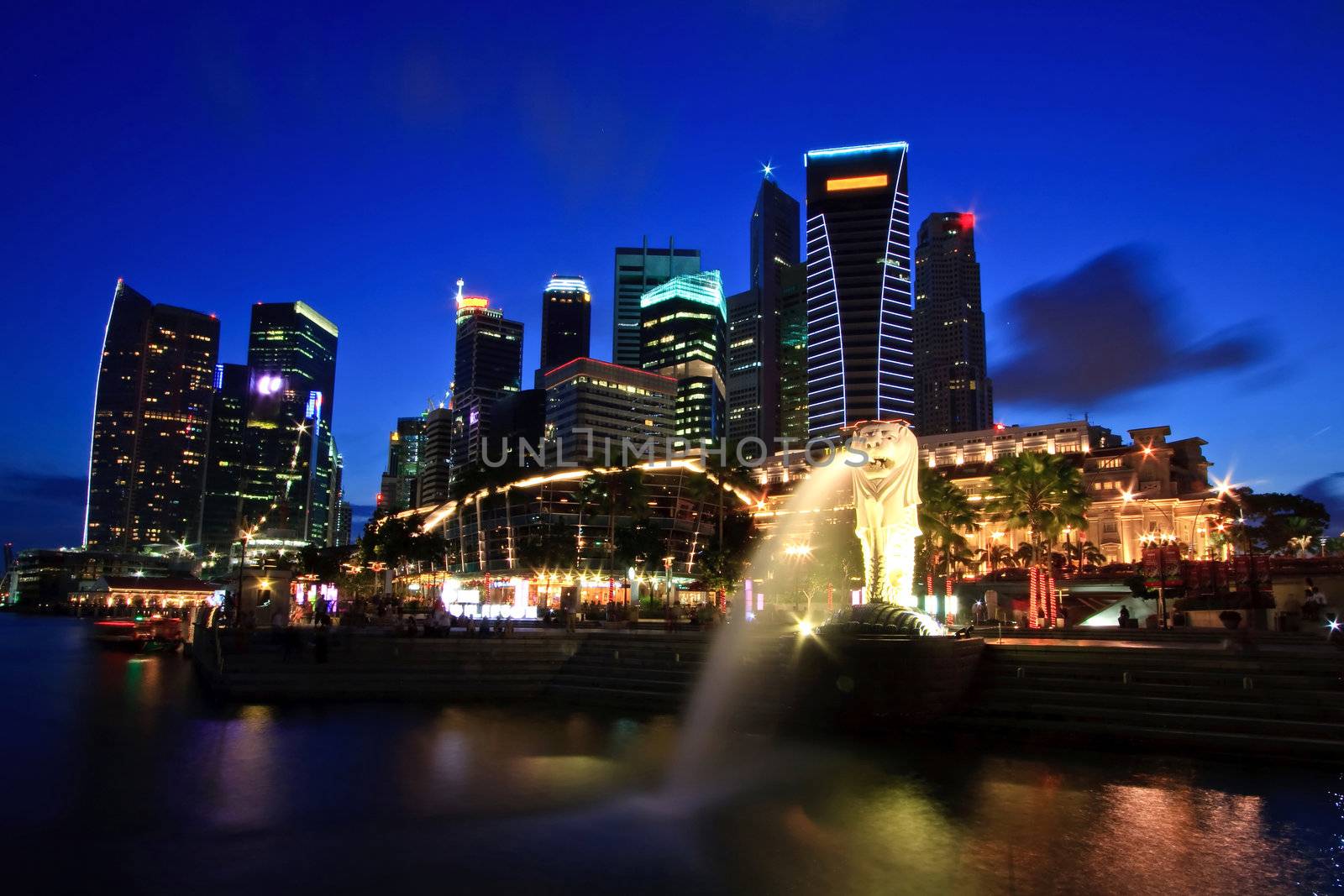 Singapore Skyline in commercial District on Merlion One Fullerton Park shine at dusk