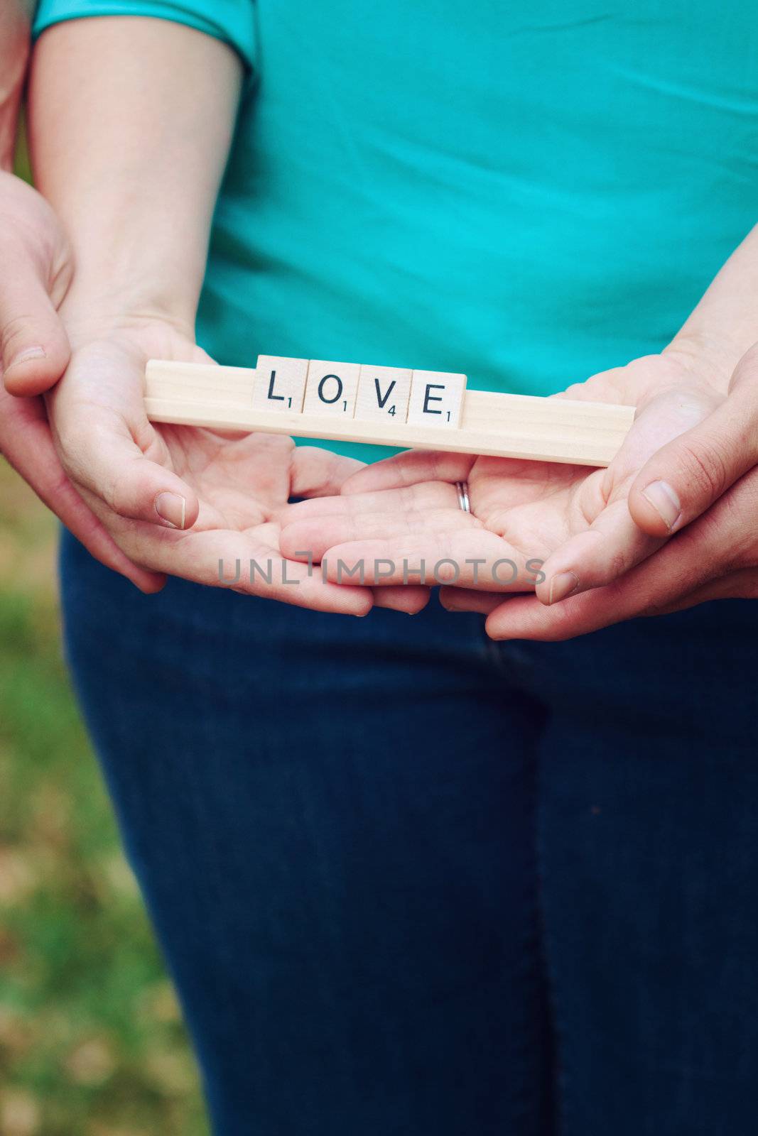 holding hands with the words love in the park