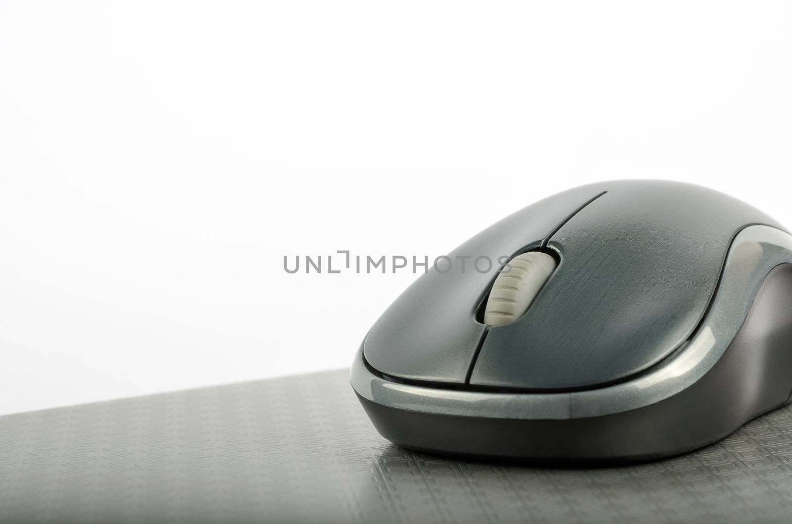 Wireless computer mouse on a metallic background
