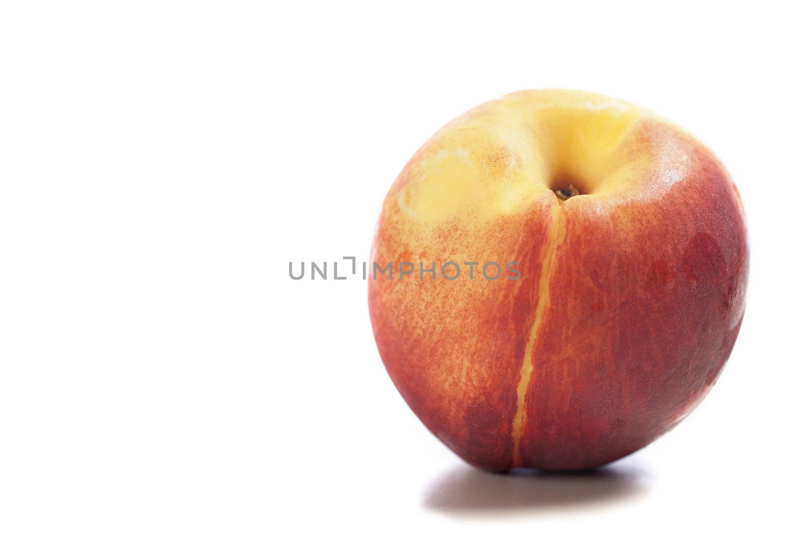 Fresh ripe nectarine on an isolated background