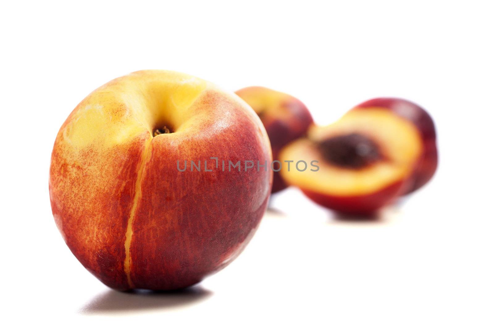 Whole and sliced fresh ripe Nectarines on an isolated background