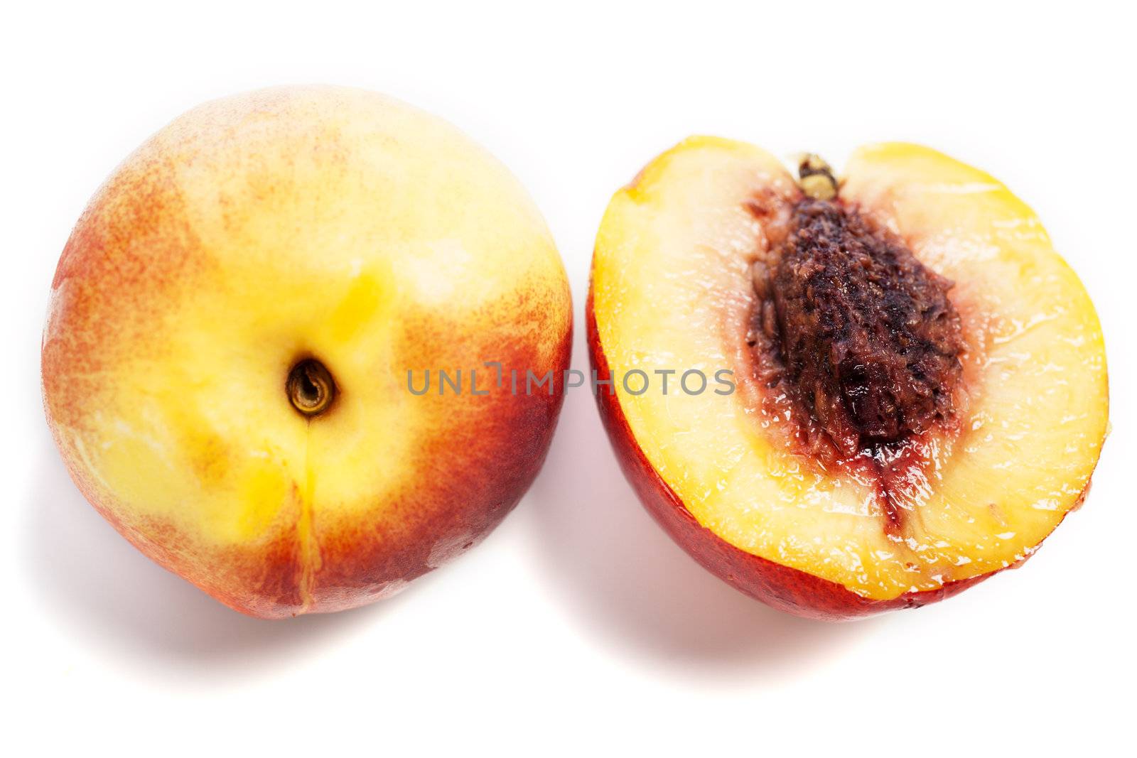 Whole and sliced fresh ripe Nectarines on an isolated background