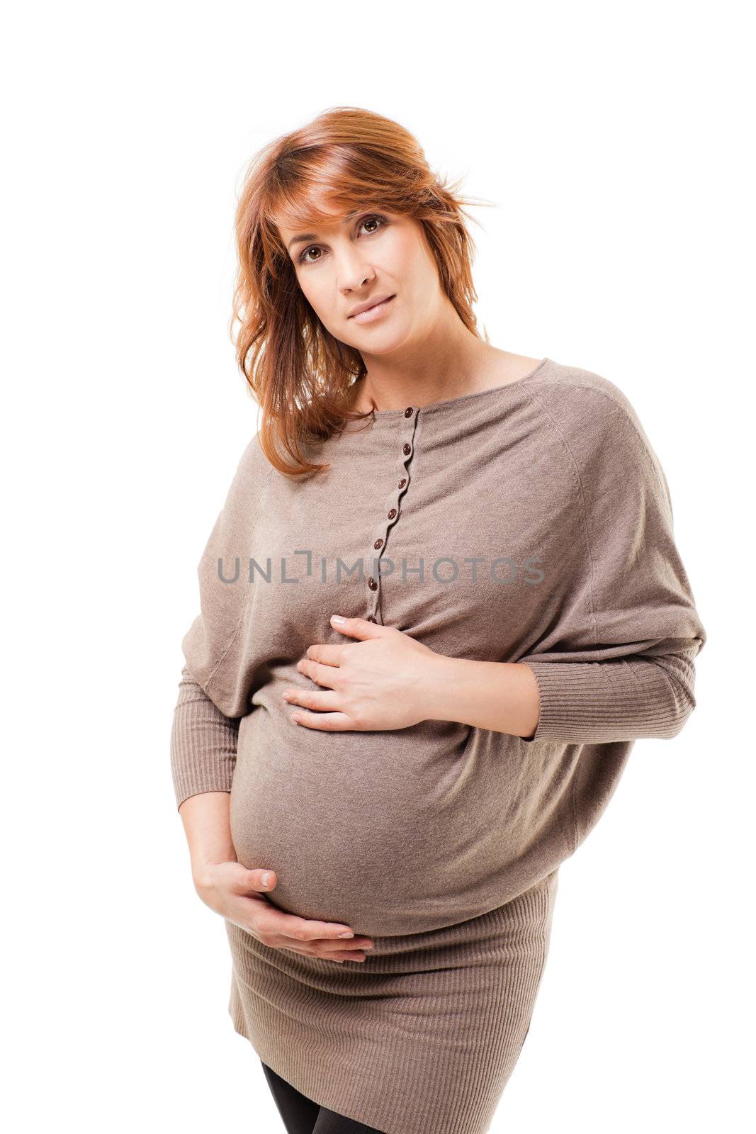Young beautiful pregnant female standing on white background holding her tummy