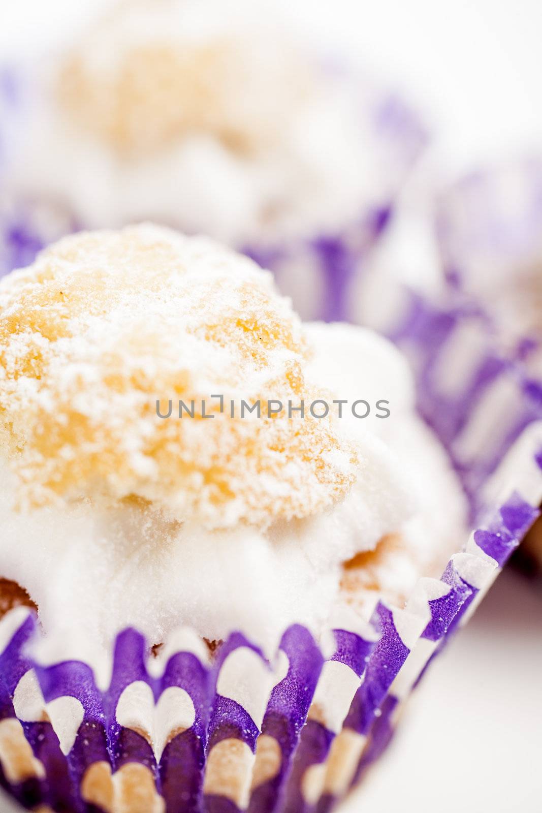 Freshly baked cup cakes with cream filling in cake trays